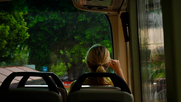 Looking out a bus window on a rainy day