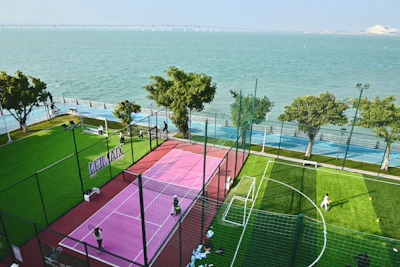 Sports courts by the ocean with people playing