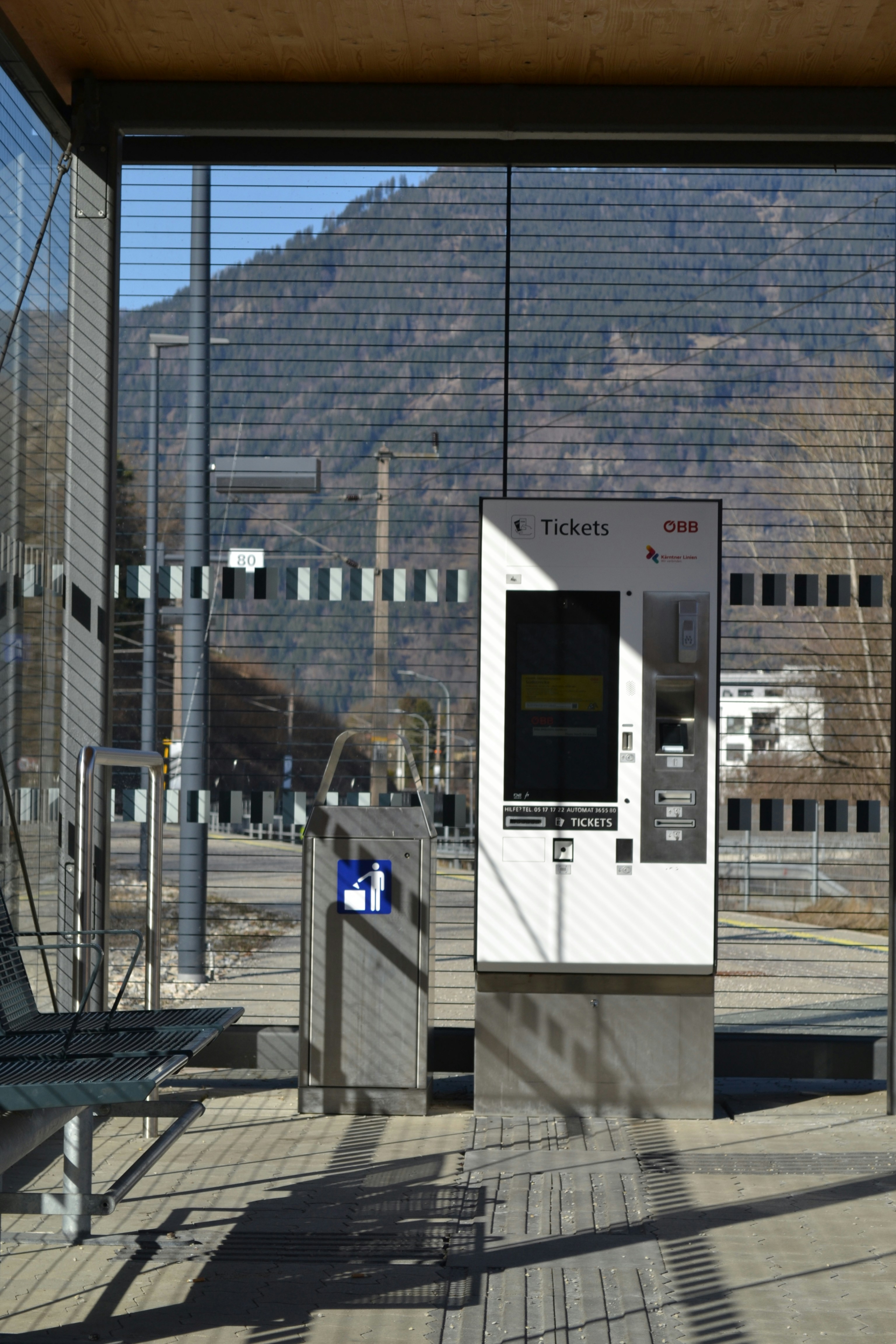 Ticket machine at a train station with mountains behind