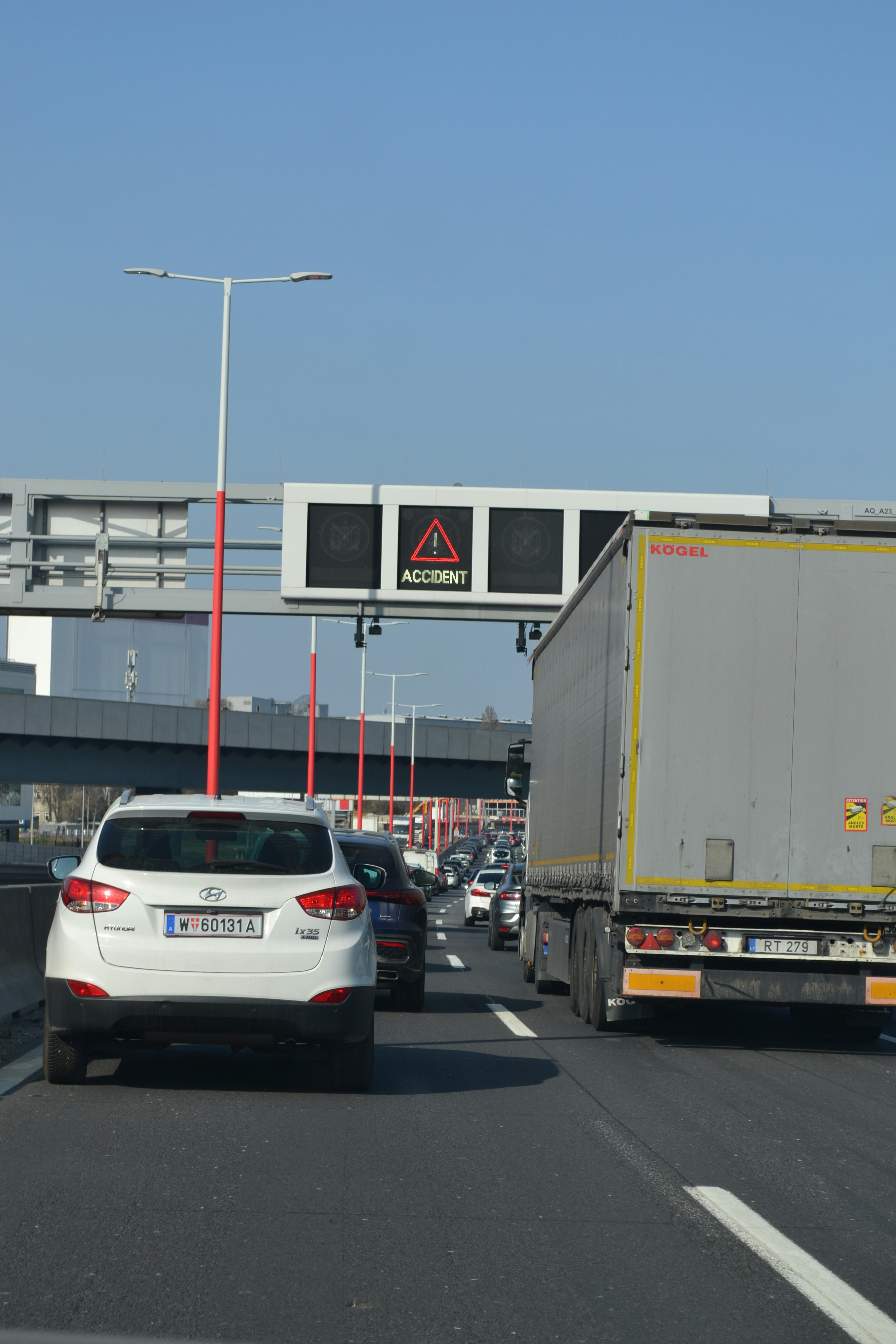 Traffic jam on highway with accident warning sign.