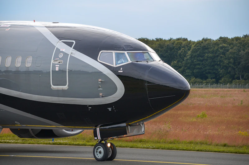 Close-up of a sleek black and grey private jet.