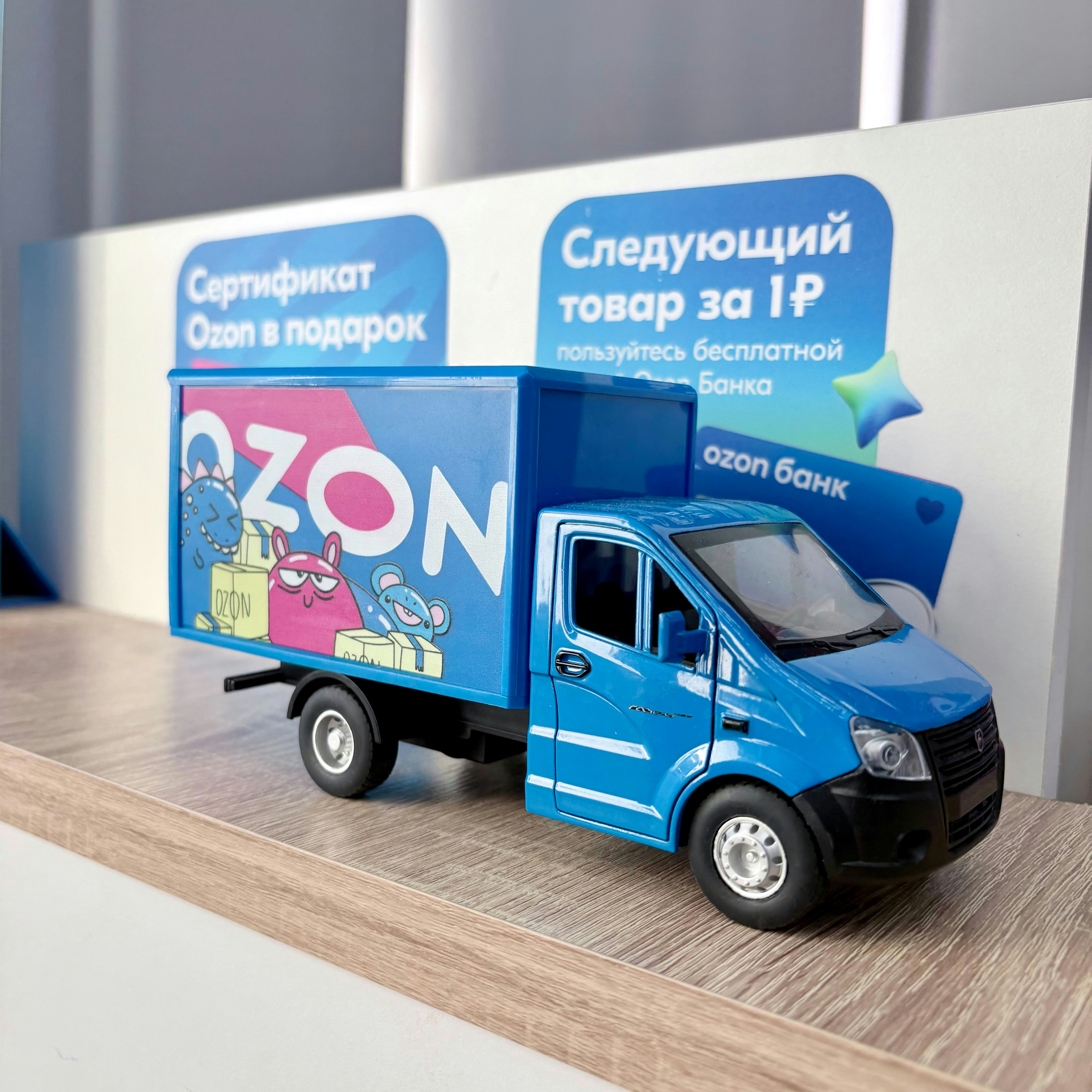 Blue delivery truck with ozon logo and cartoon characters