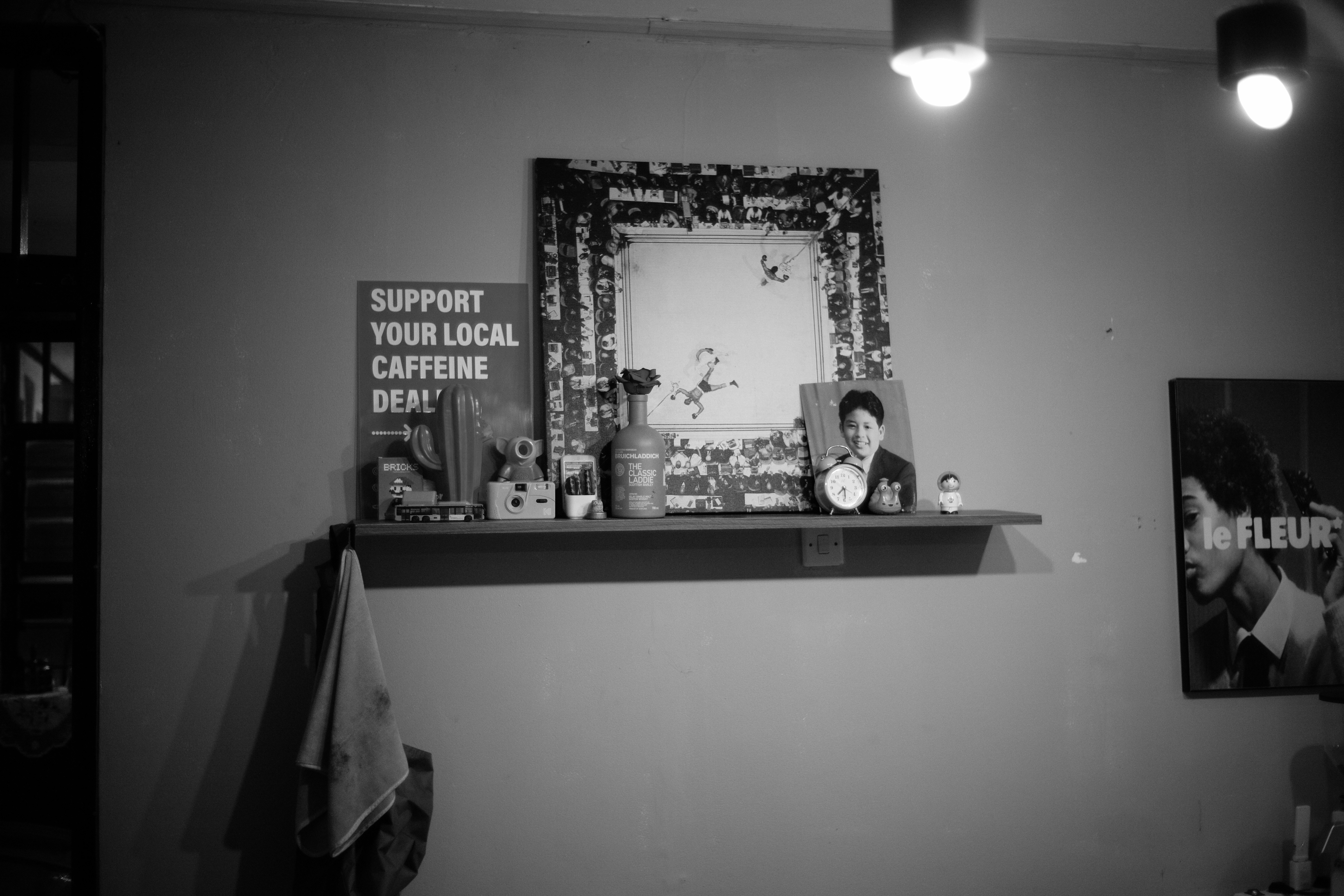 Prateleira com arte emoldurada, fotos e itens decorativos.