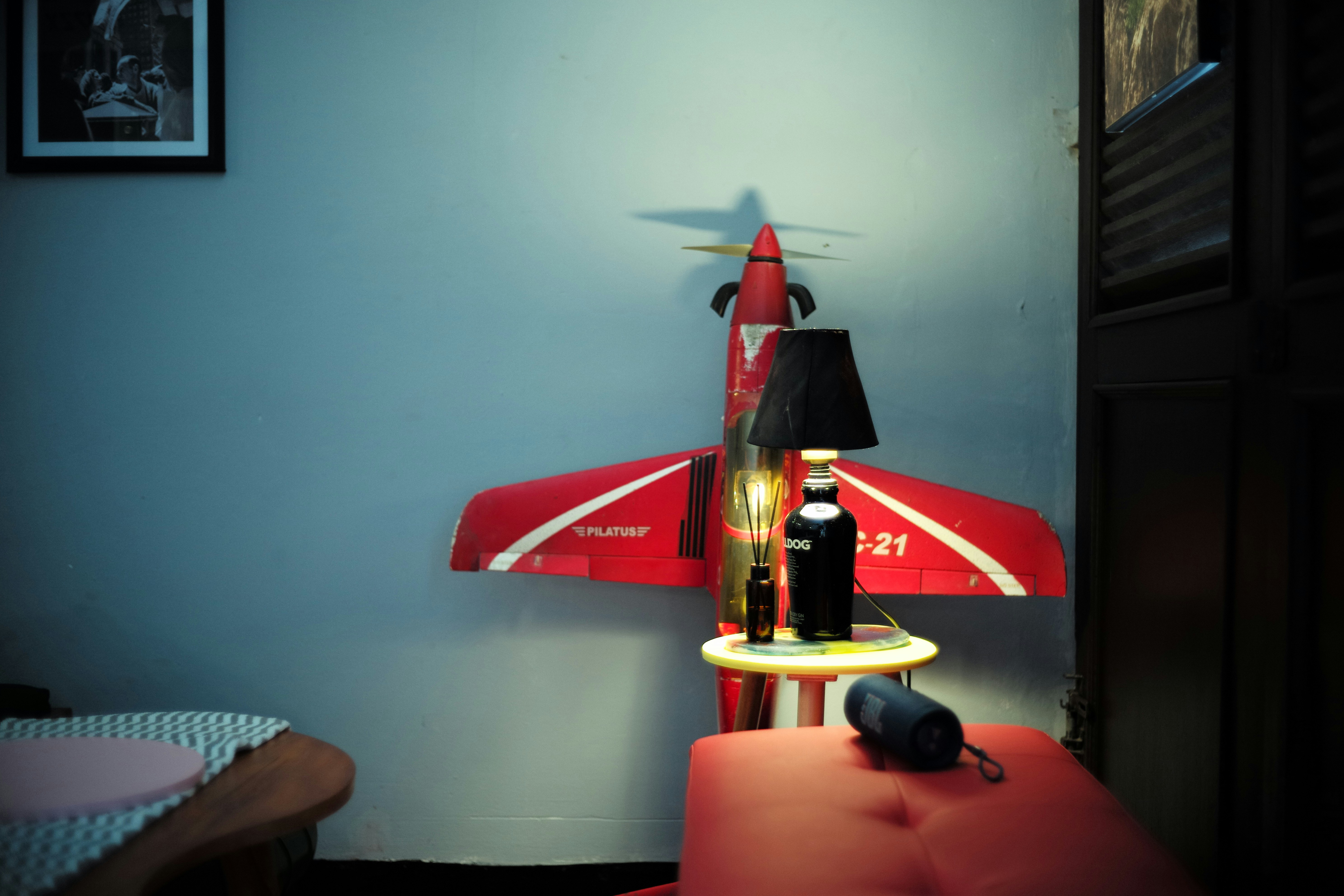 Red airplane model with lamp on table
