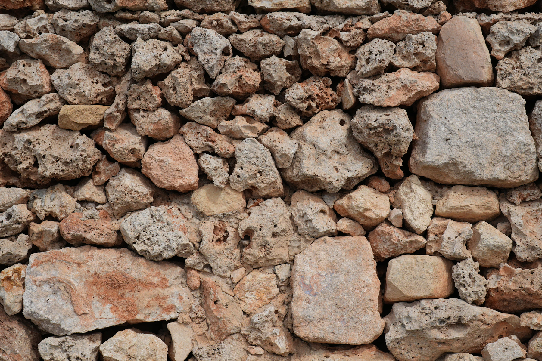 Natural stone wall showing varied shapes and surface textures