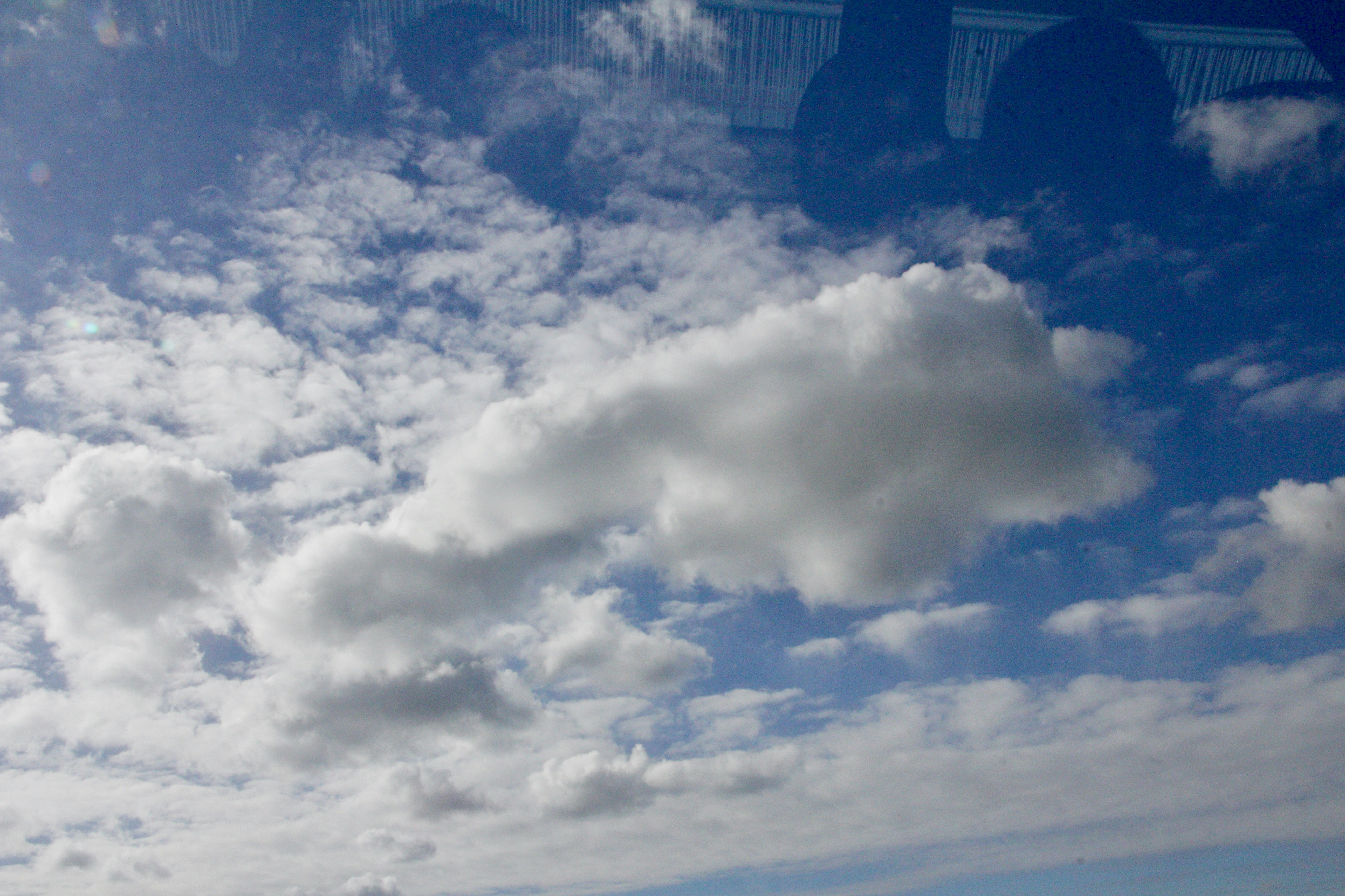 Fluffy white clouds against a bright blue sky