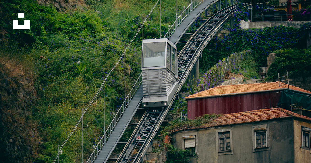 Funicular In House Funicular ascends a steep track beside old buildings. photo – Free ...