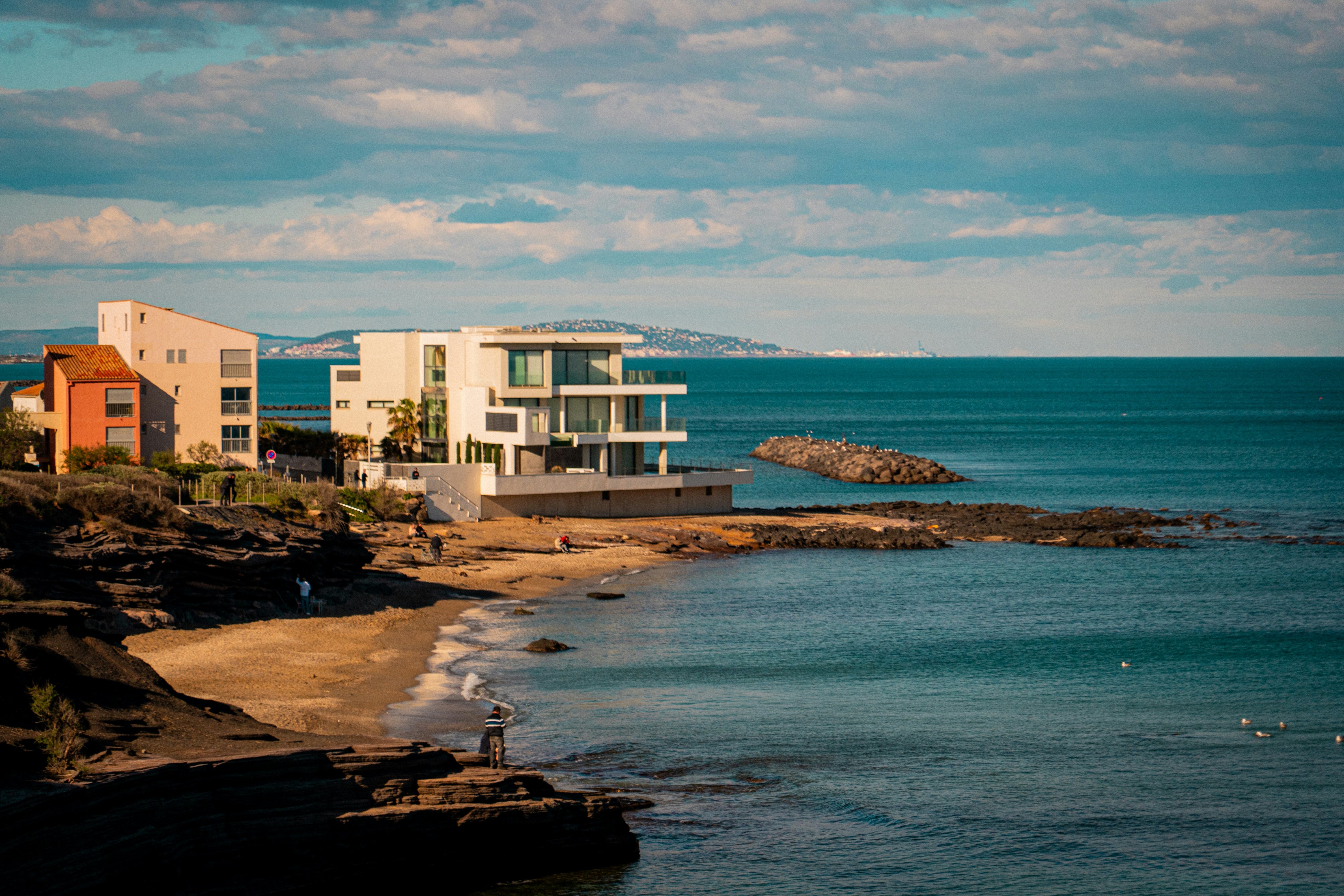 Modern houses on a rocky coastline overlooking the sea