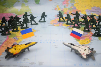 Toy soldiers and jets on map with flags