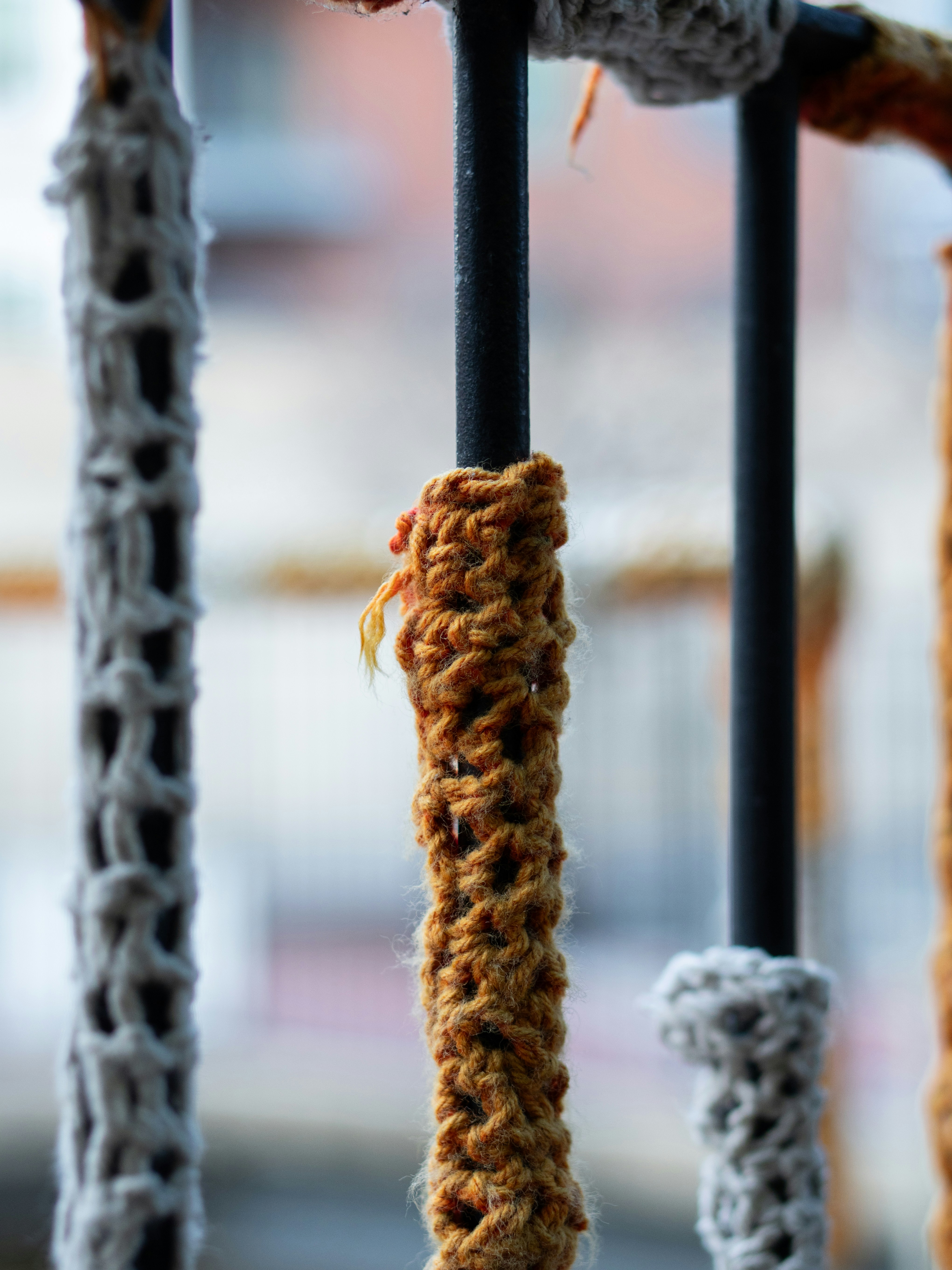 Rods wrapped in knitted yarn with blurred background
