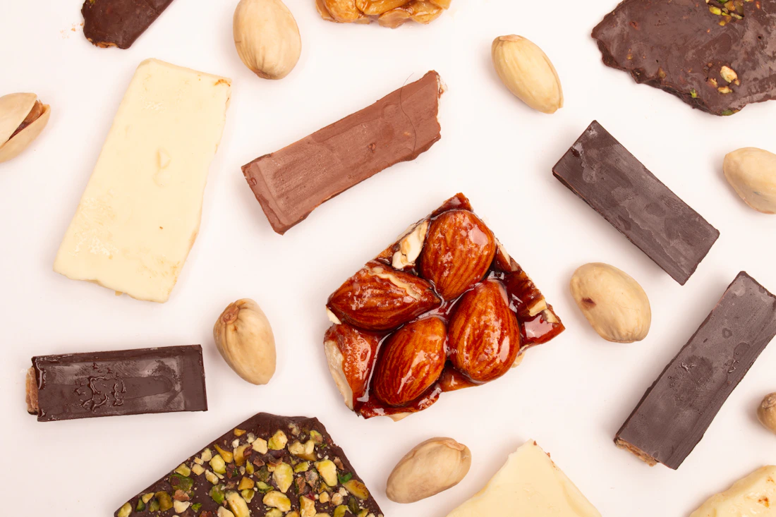 An assortment of chocolate and nuts on a light surface