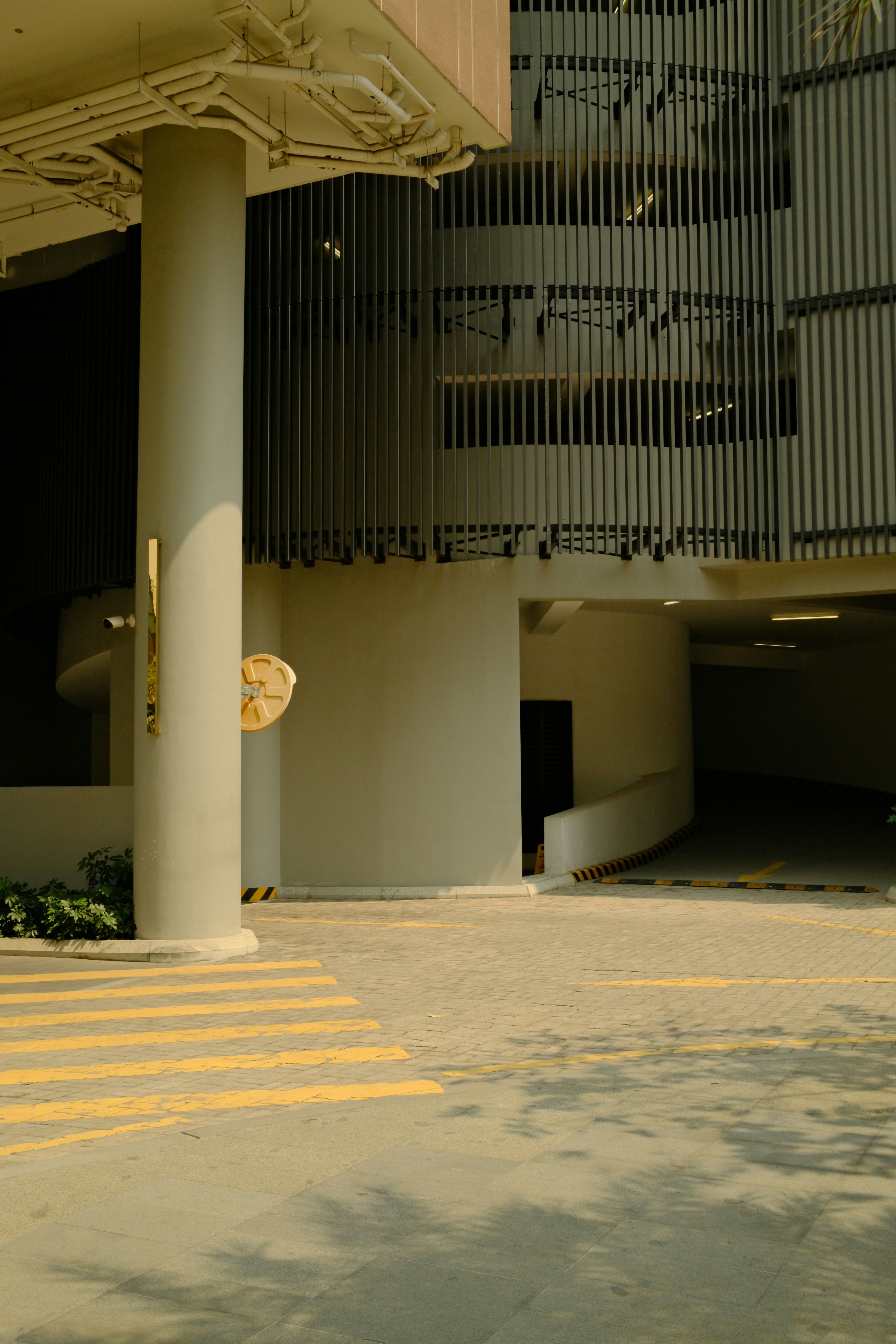 Modern concrete parking garage with yellow lines.
