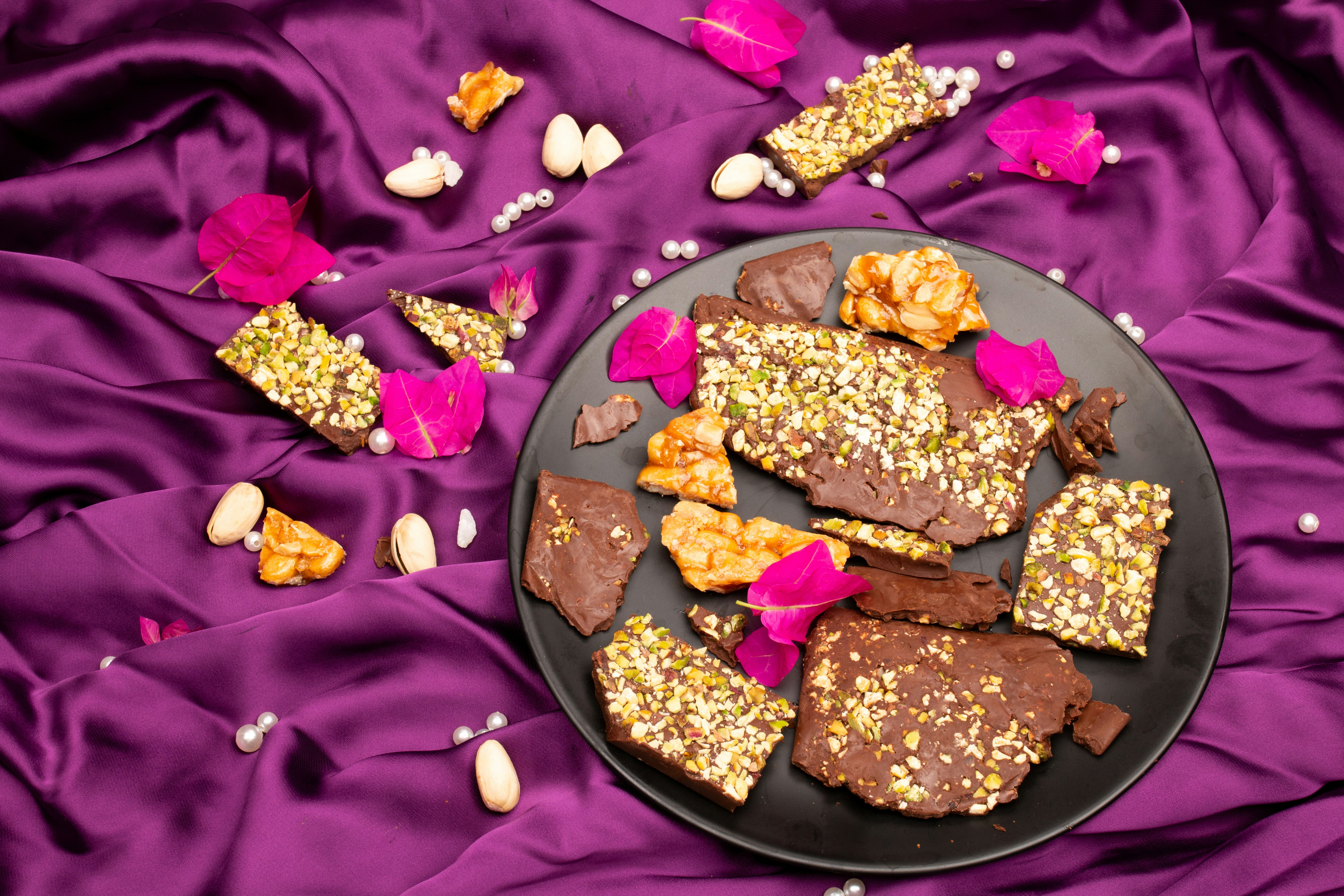 Chocolate y nuez esparcidos sobre seda morada.