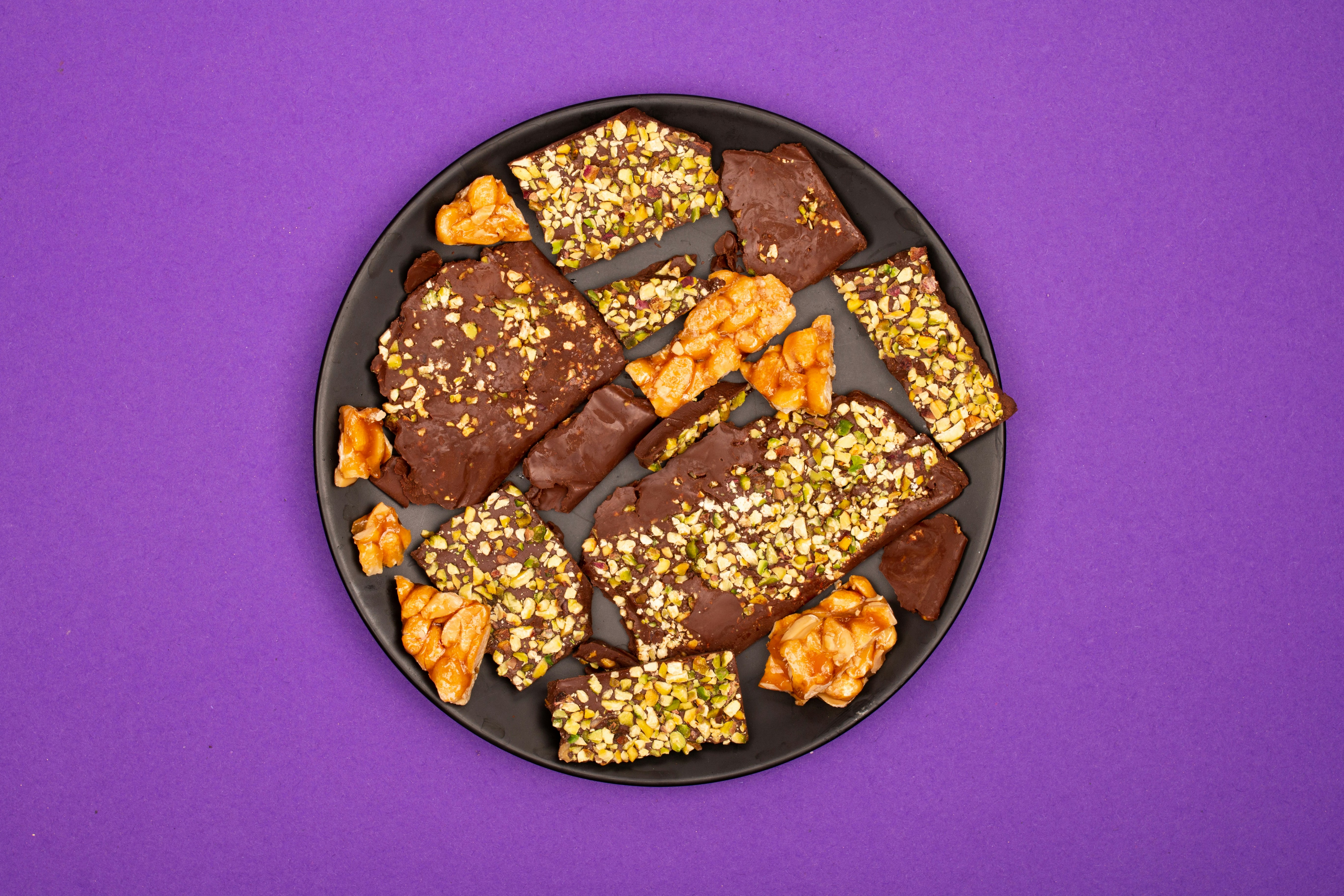 Chocolate bark with nuts and honeycomb on a plate.