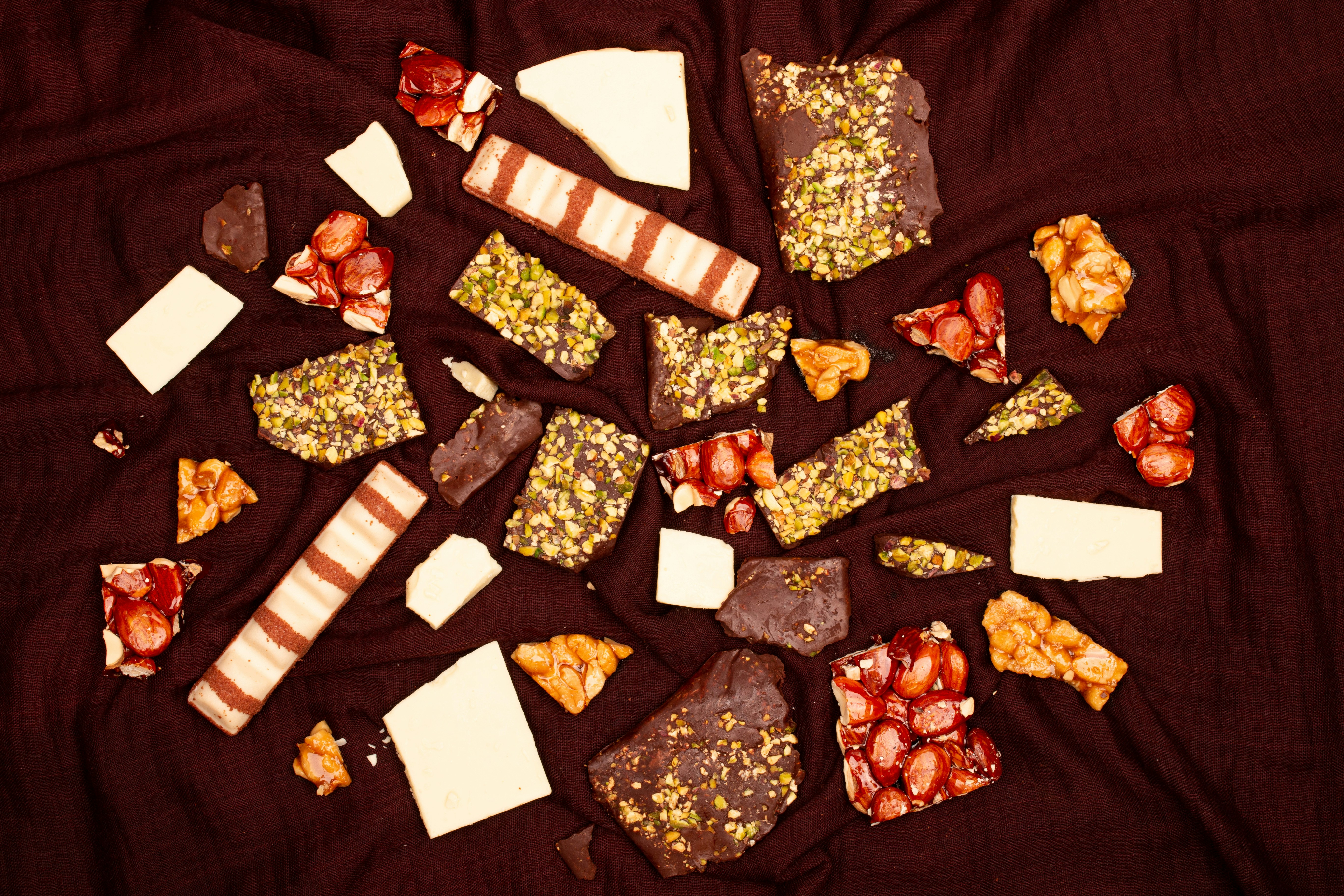 Assortment of broken chocolate bars and sweets photo – Free Food Image ...