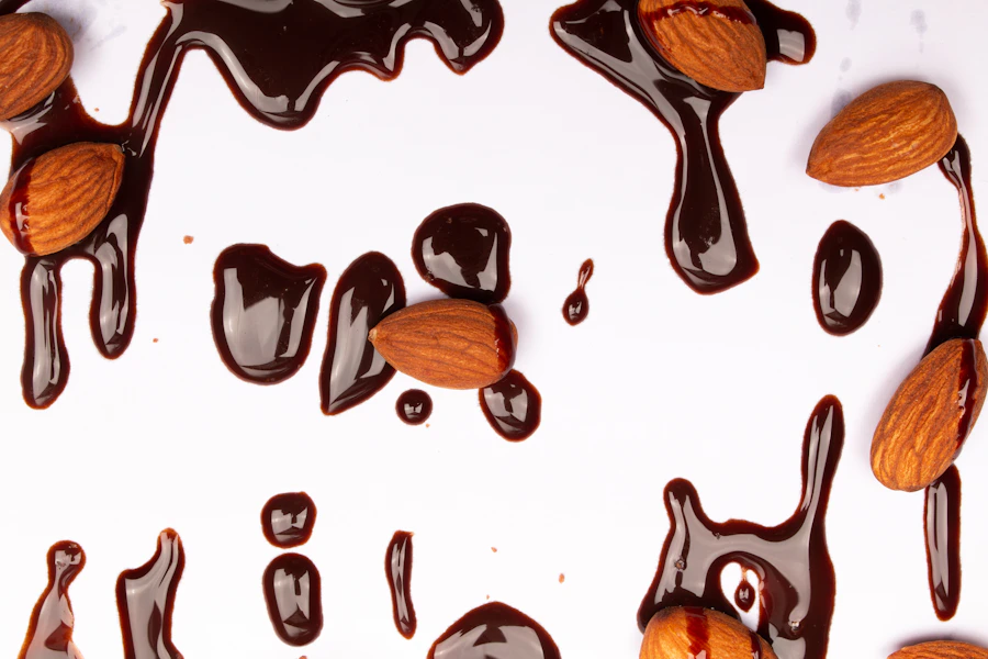 Almonds paired with chocolate on a light surface