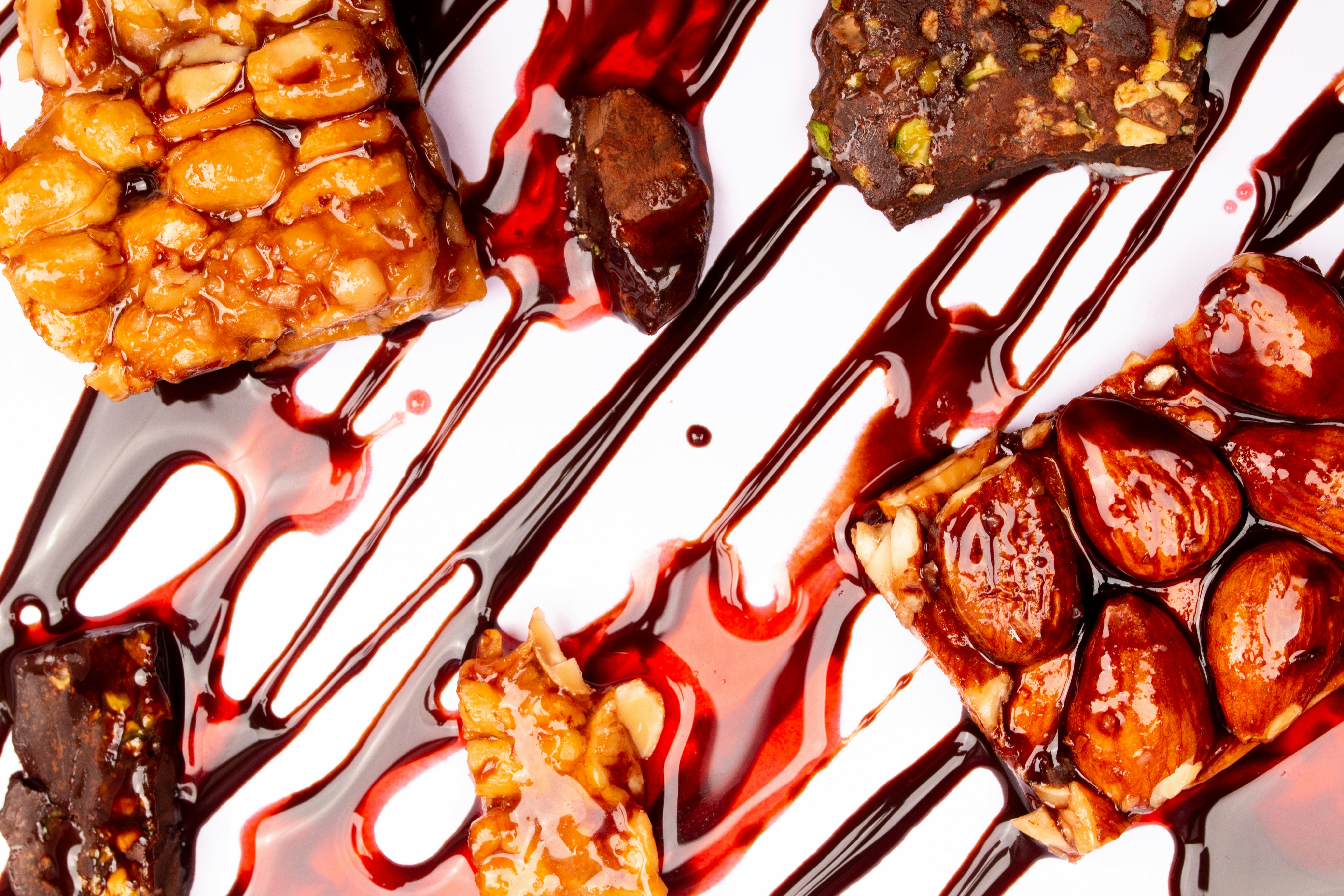 Assortment of sweet bars drizzled with dark chocolate sauce