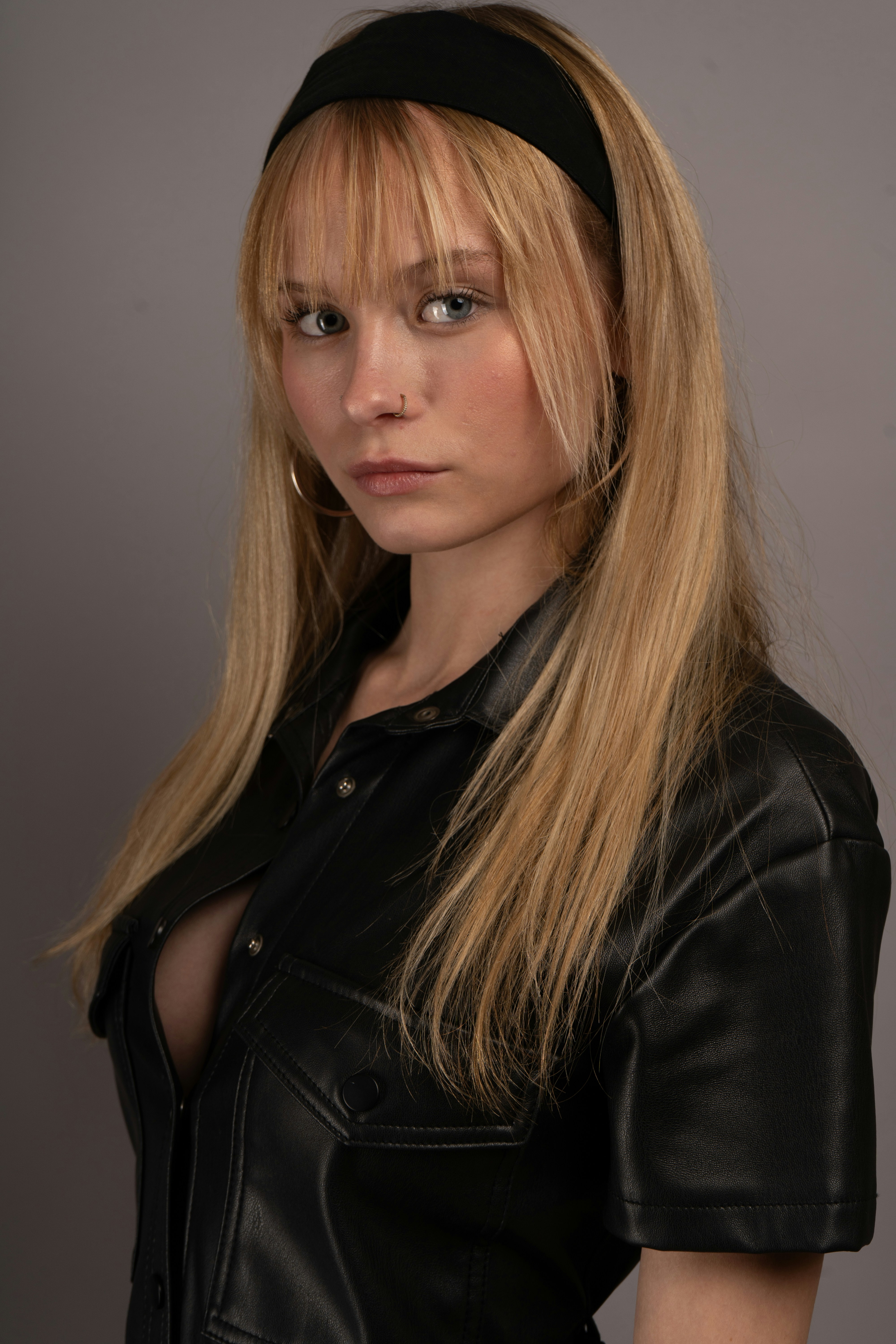 A young woman with blonde hair and a black headband