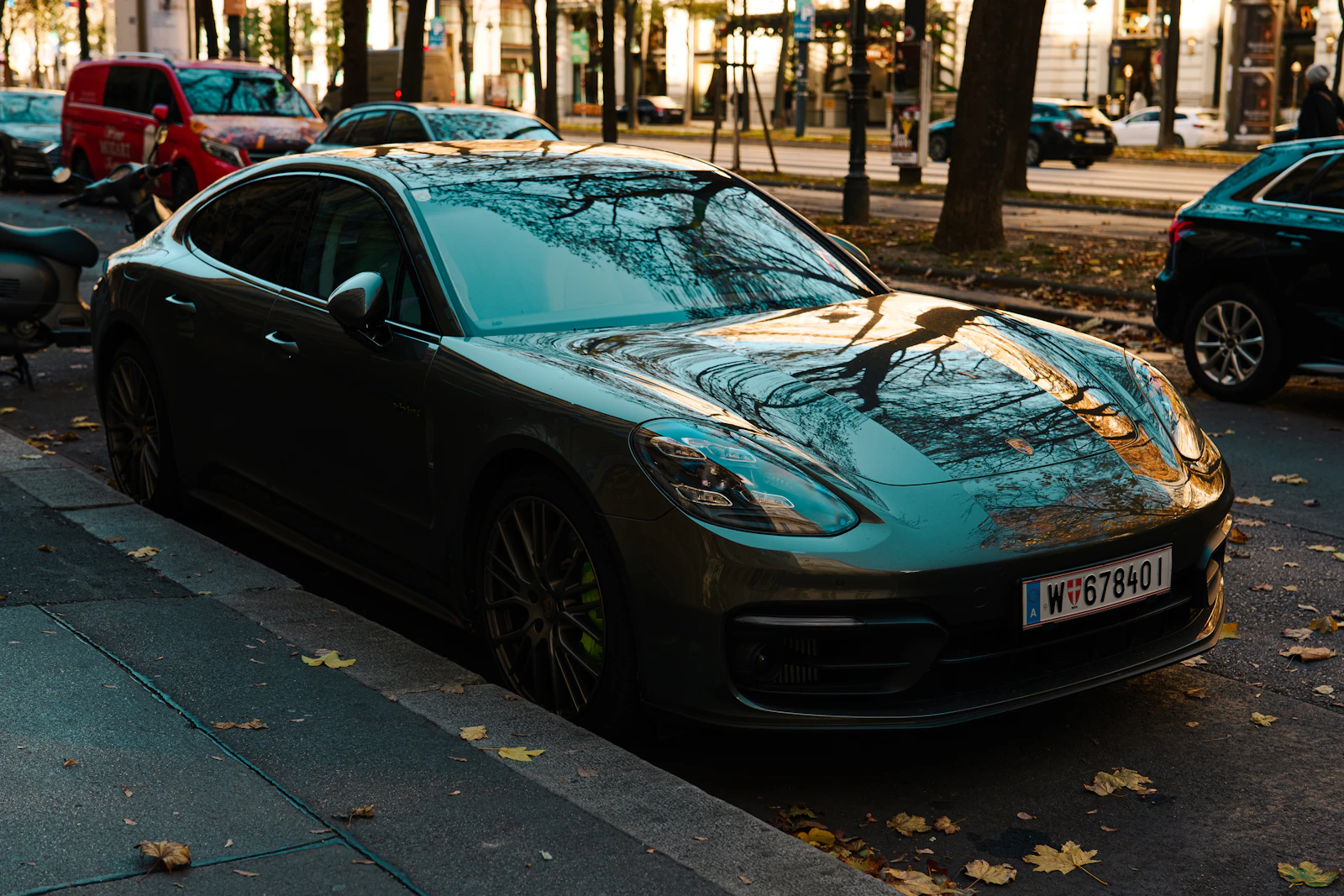 Dark grey Porsche parked on a city street outside the studio