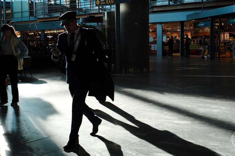 Traveller walking through a sunlit modern airport terminal