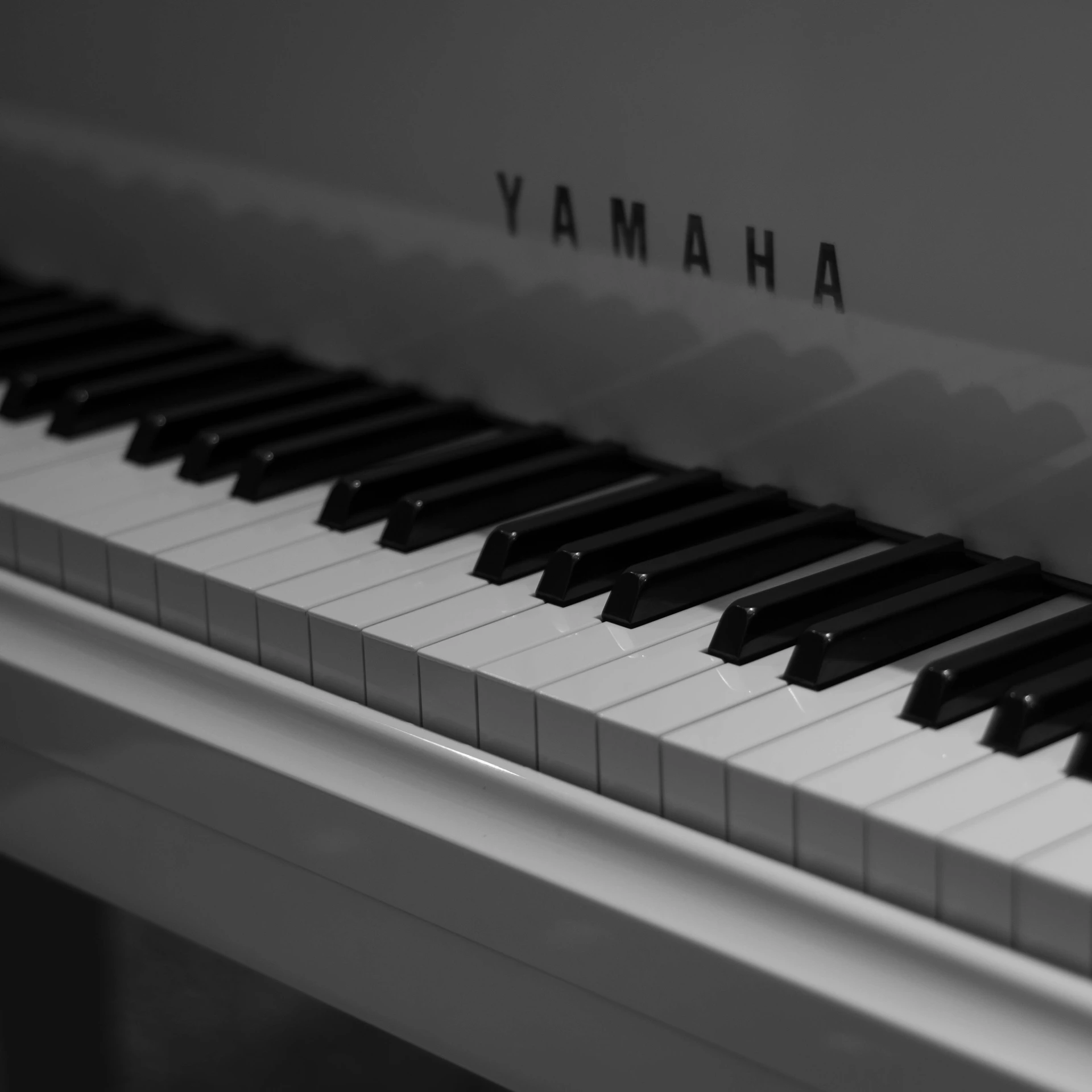 Close-up of a white yamaha piano keys.