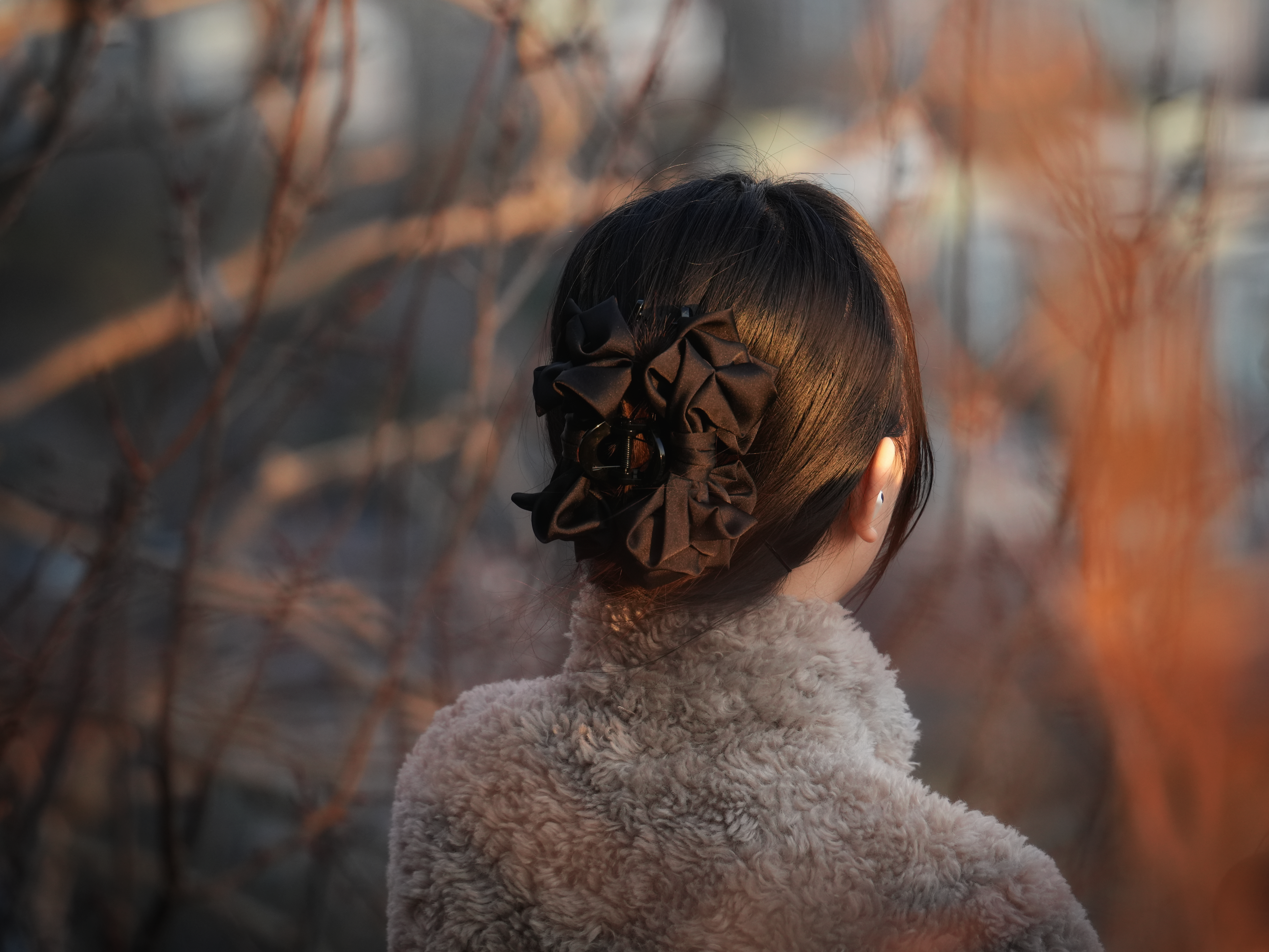 Woman with dark hair and a fuzzy sweater.