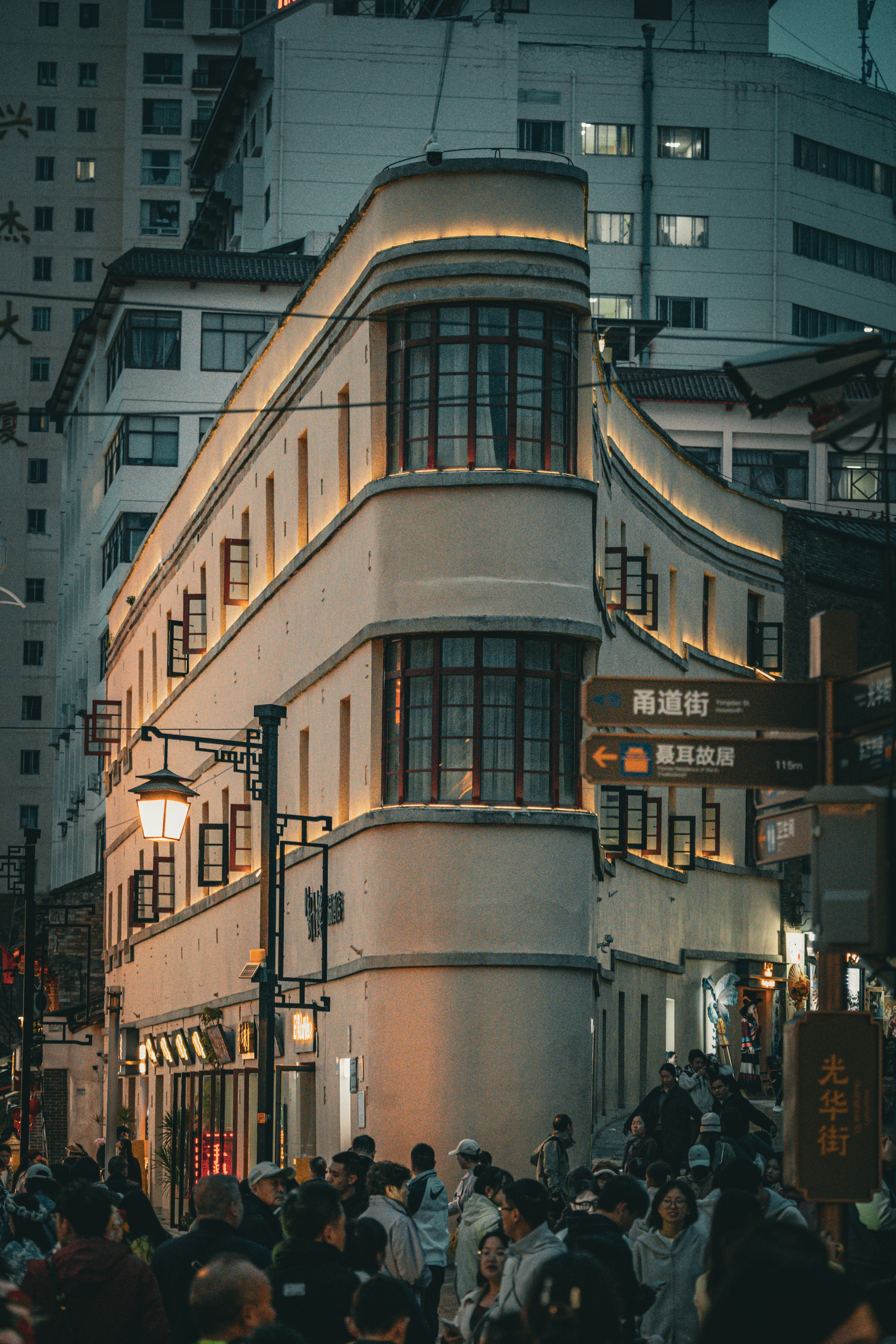 A historic building on a busy street at night.