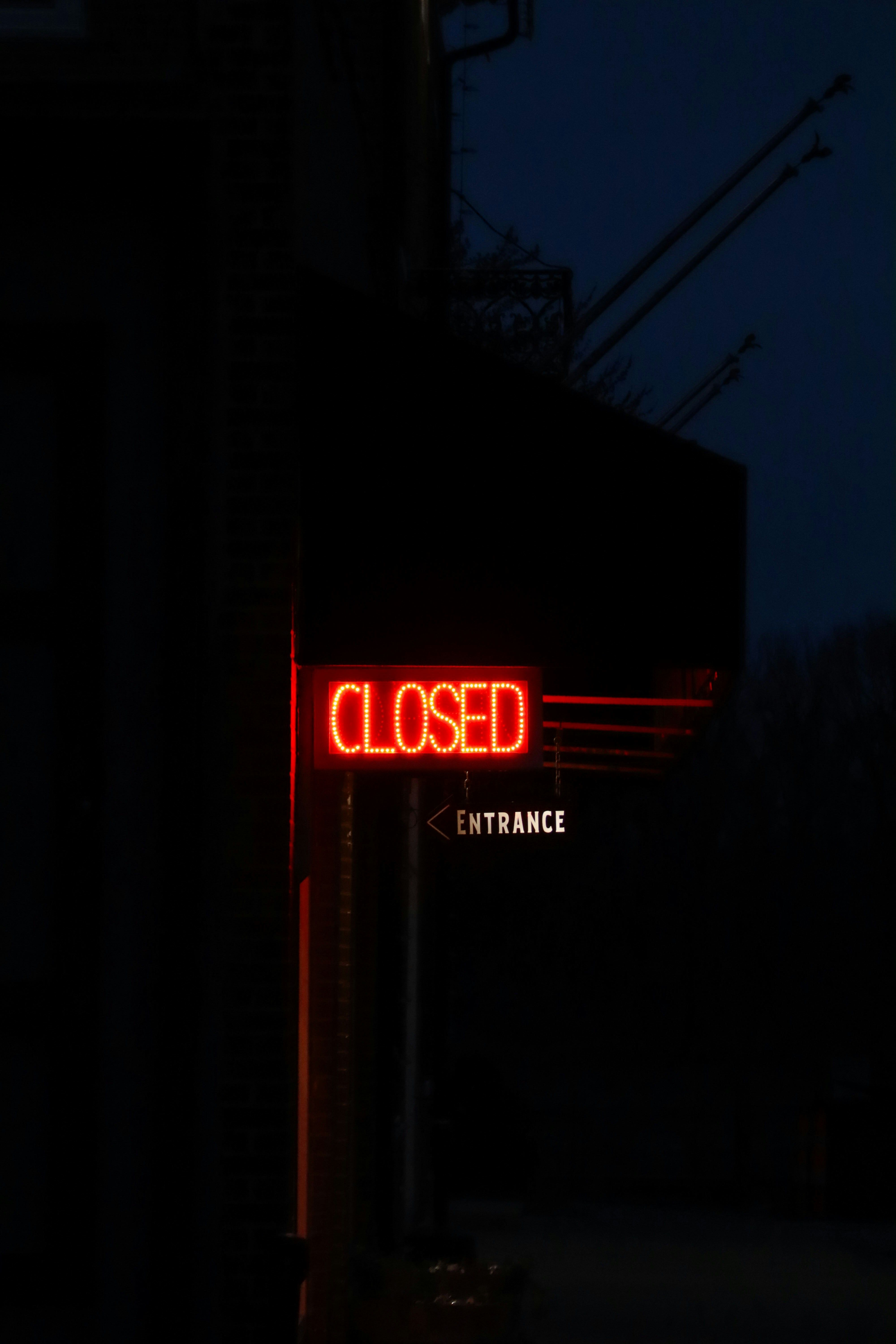 Red neon "closed" sign illuminates the night.