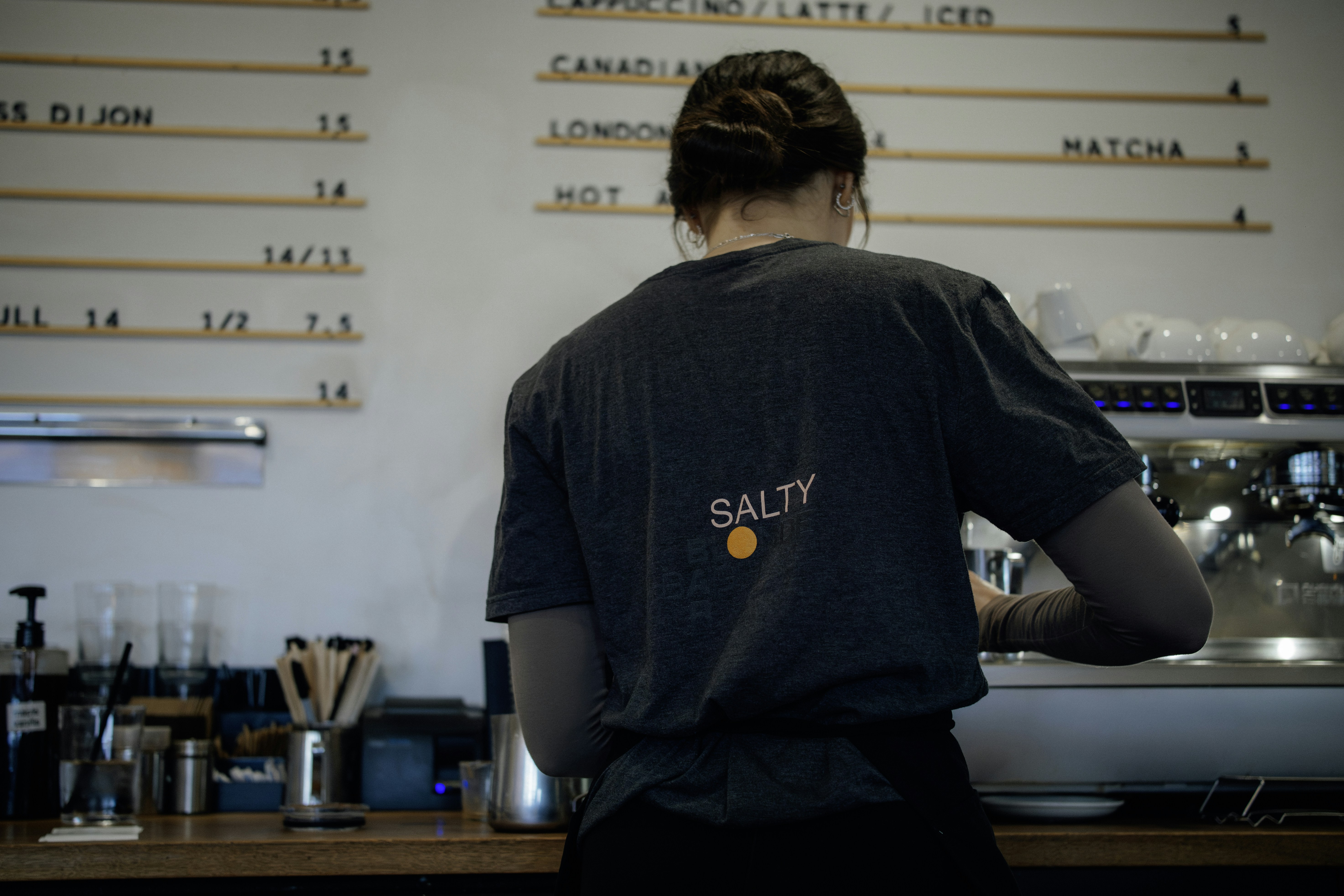 Barista working behind a coffee counter