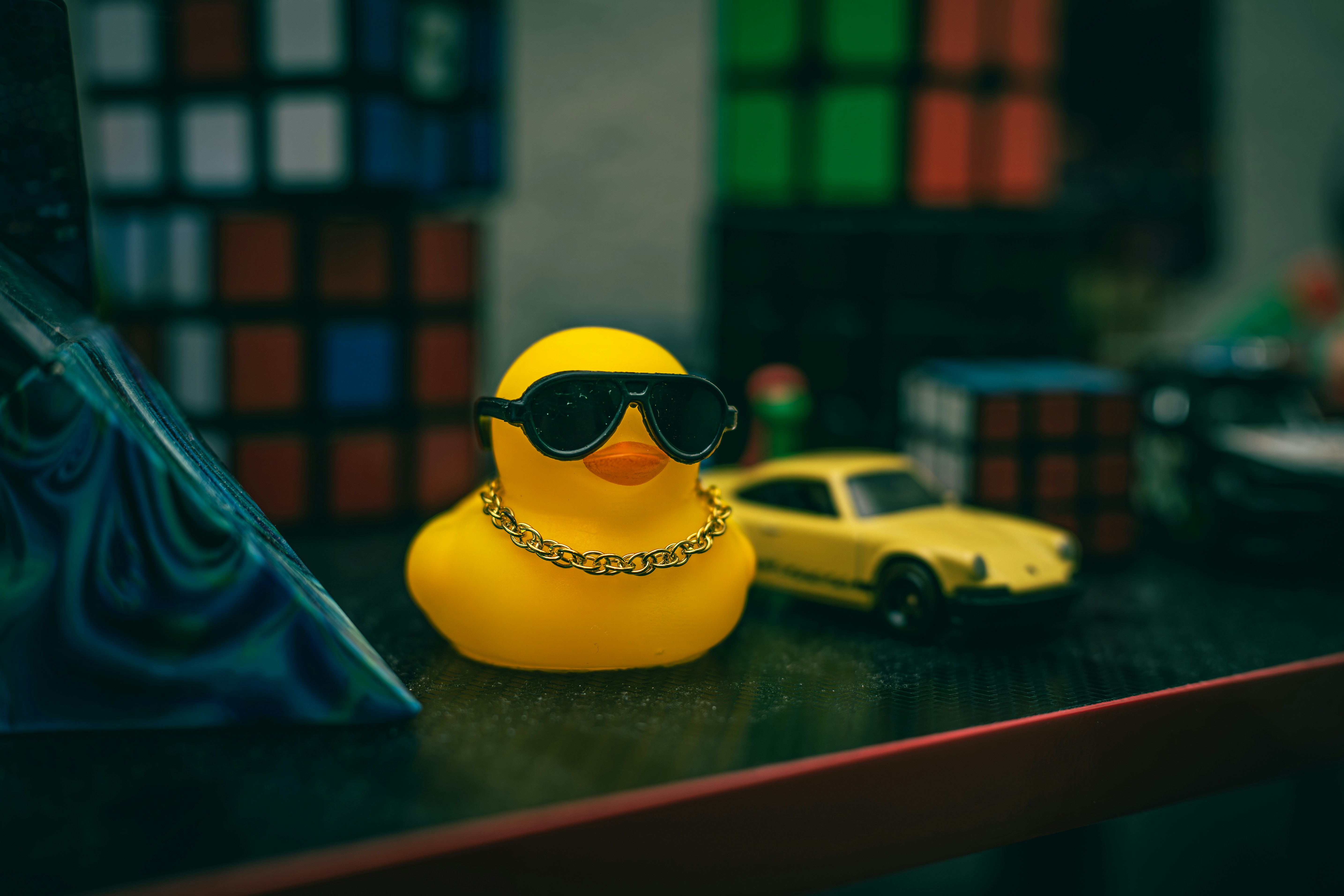 A rubber duck wearing sunglasses and a gold chain.