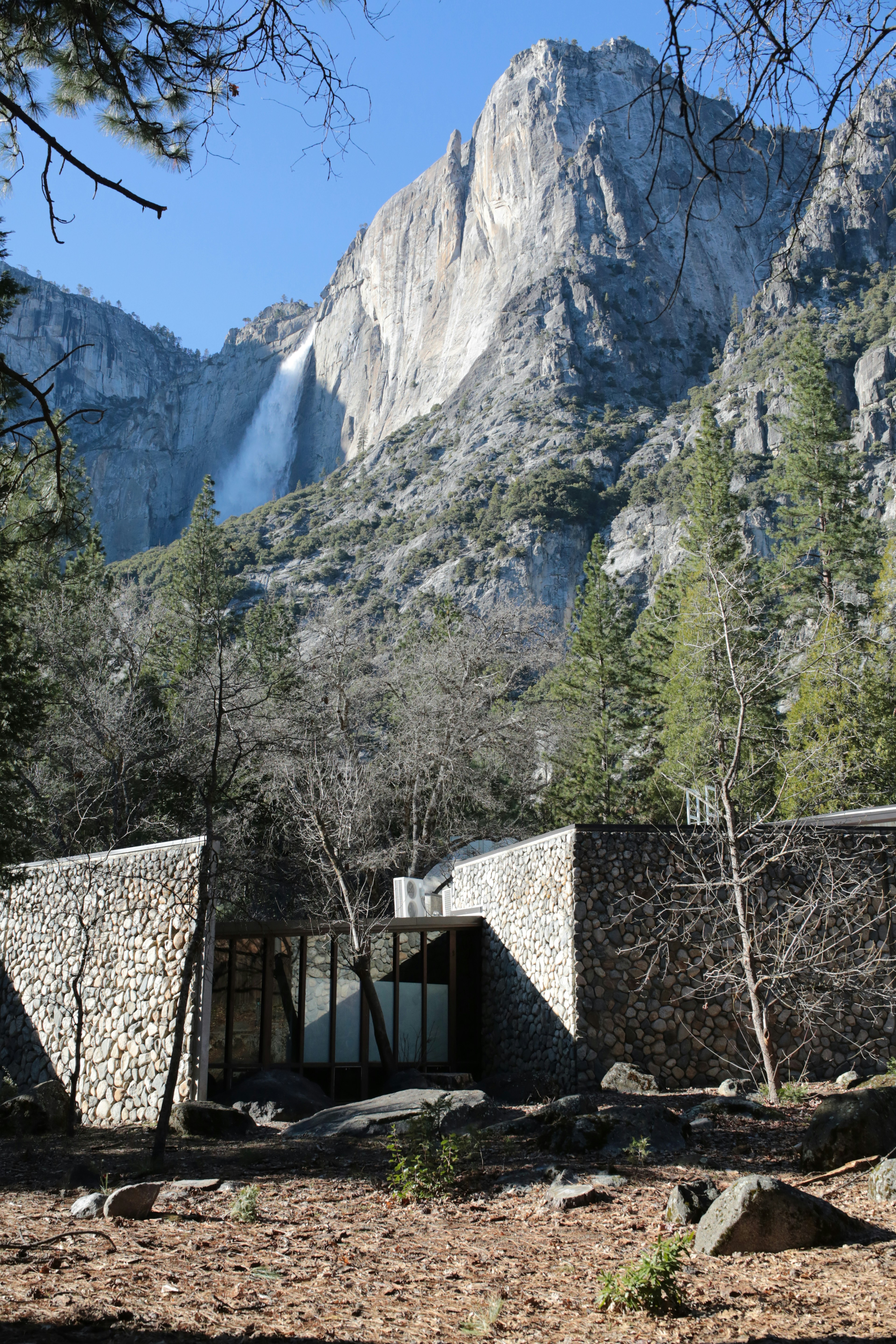 Stone building with waterfall in background