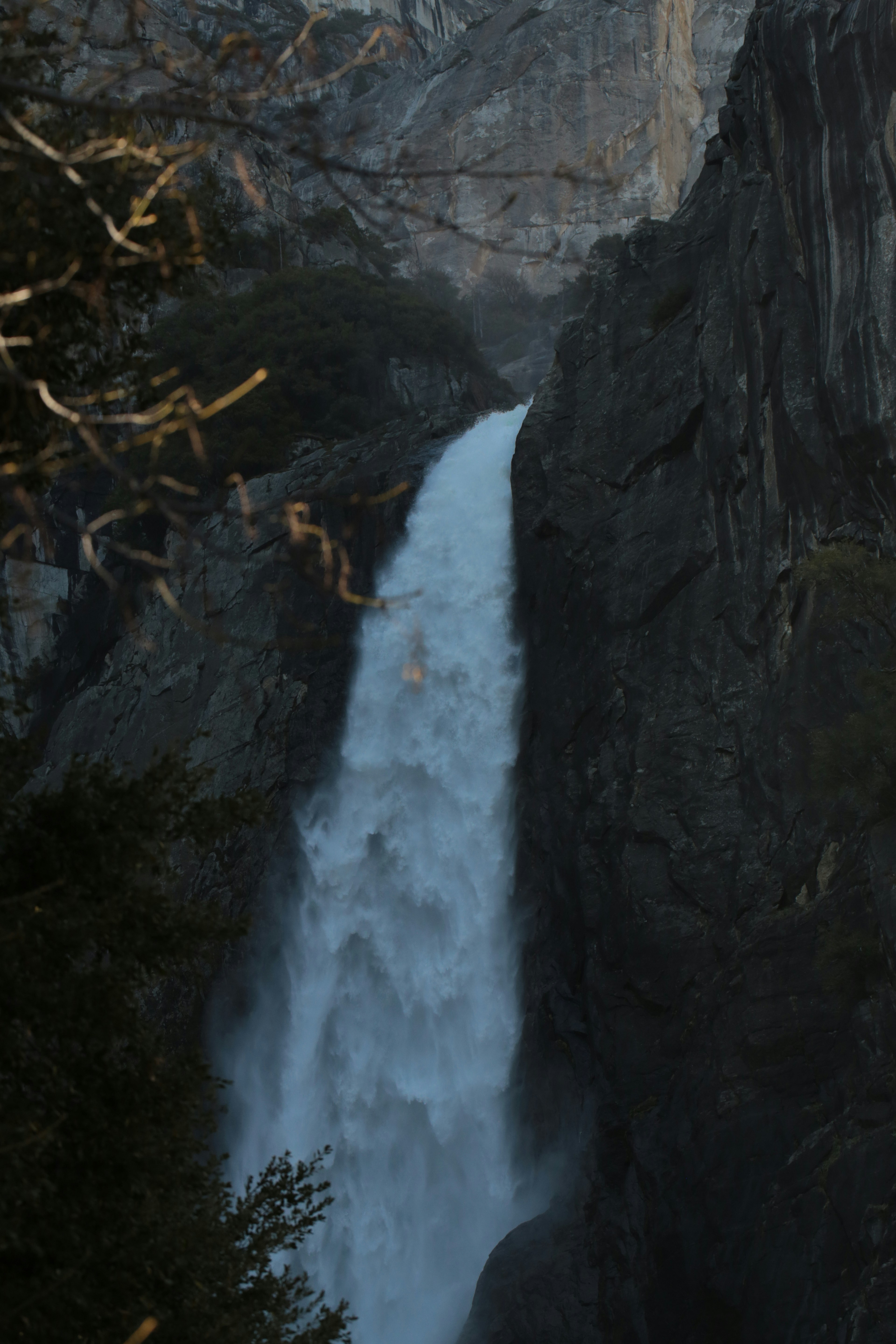 A powerful waterfall cascades down a rocky cliff face.