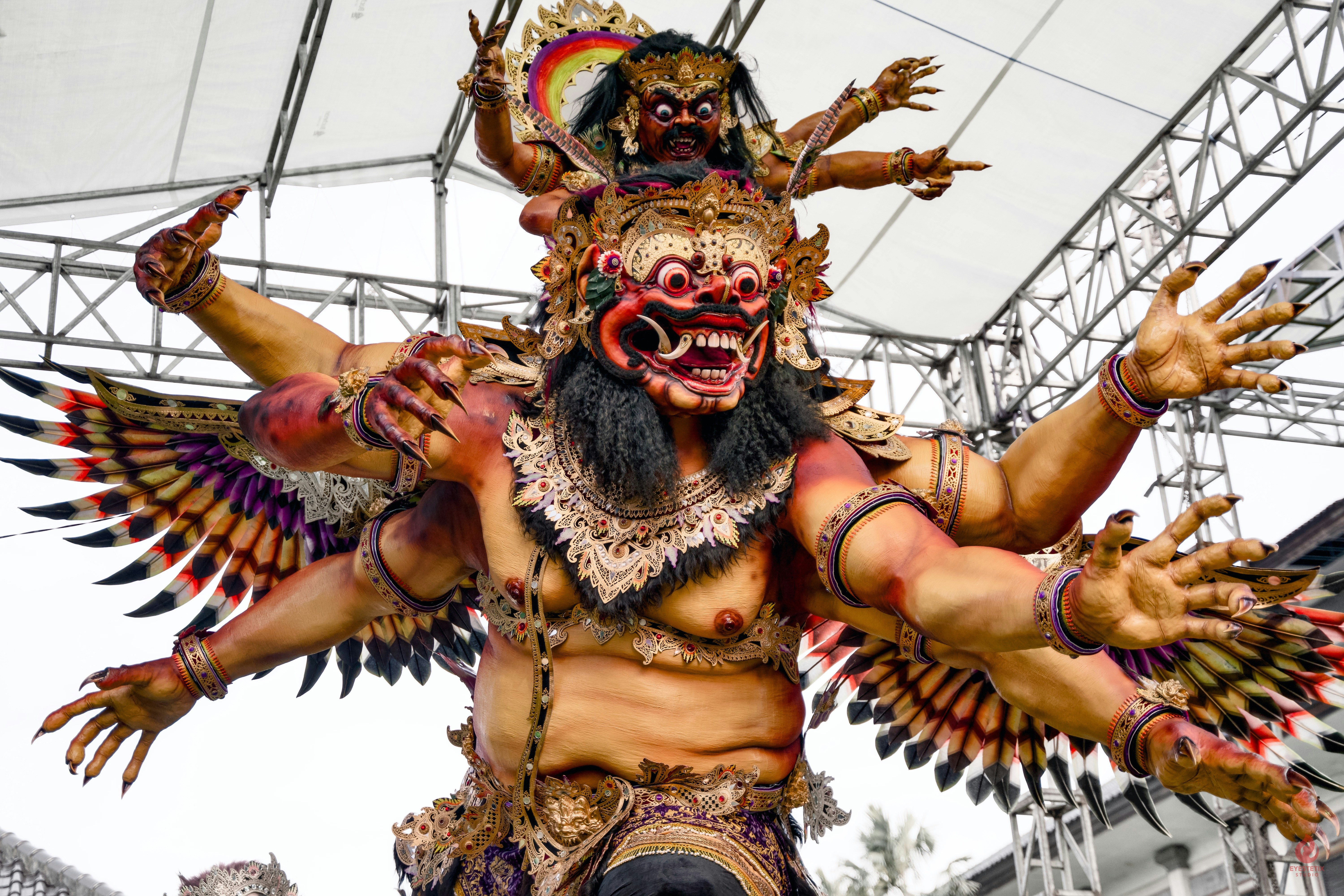 A large, multi-armed mythological creature with a fierce face.