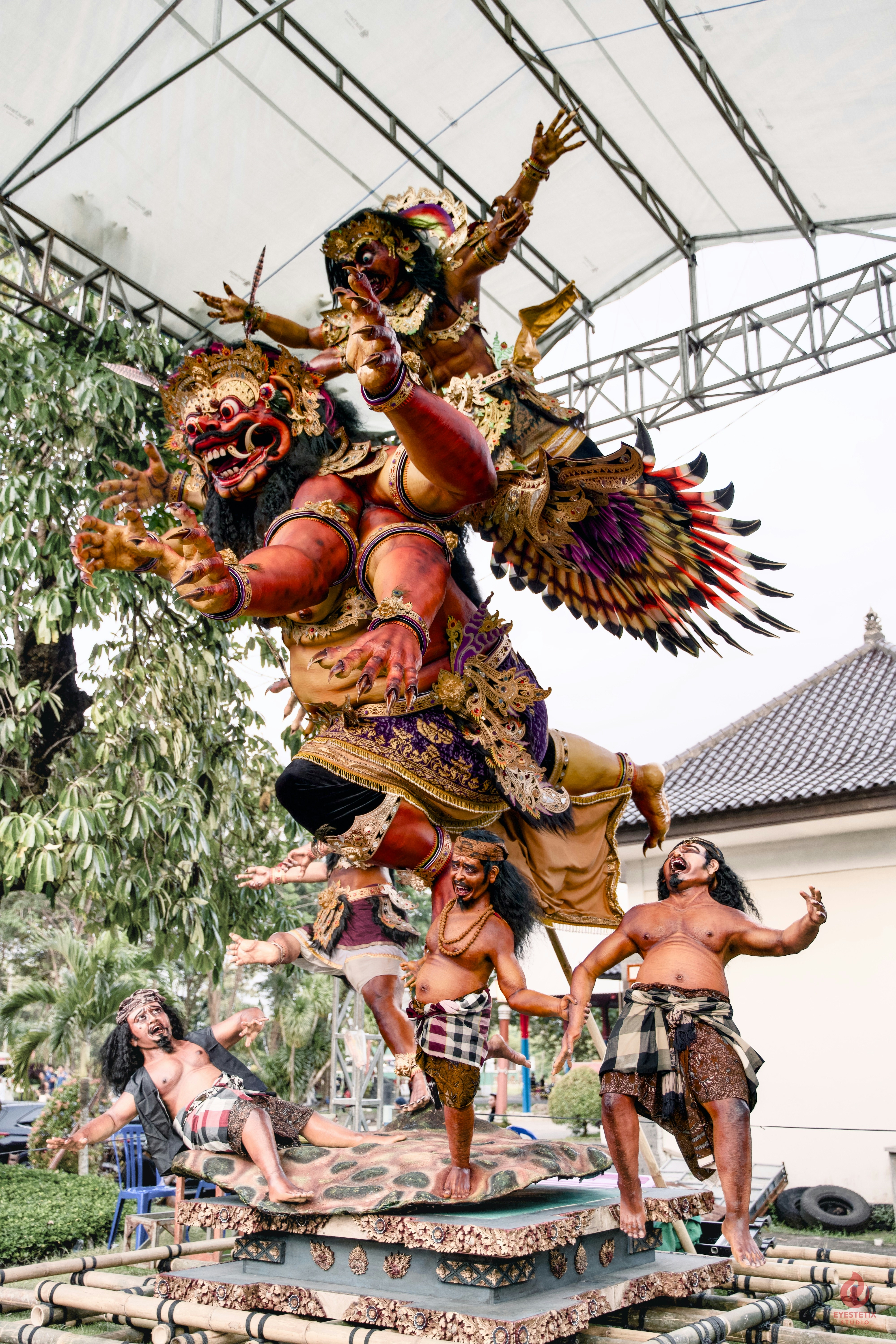 Giant mythological effigy with figures in dynamic poses