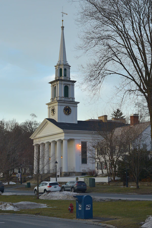 A white New England church with a tall steeple