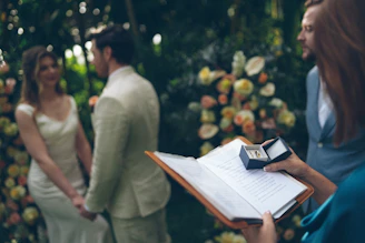 Wedding ceremony with rings and officiant holding book