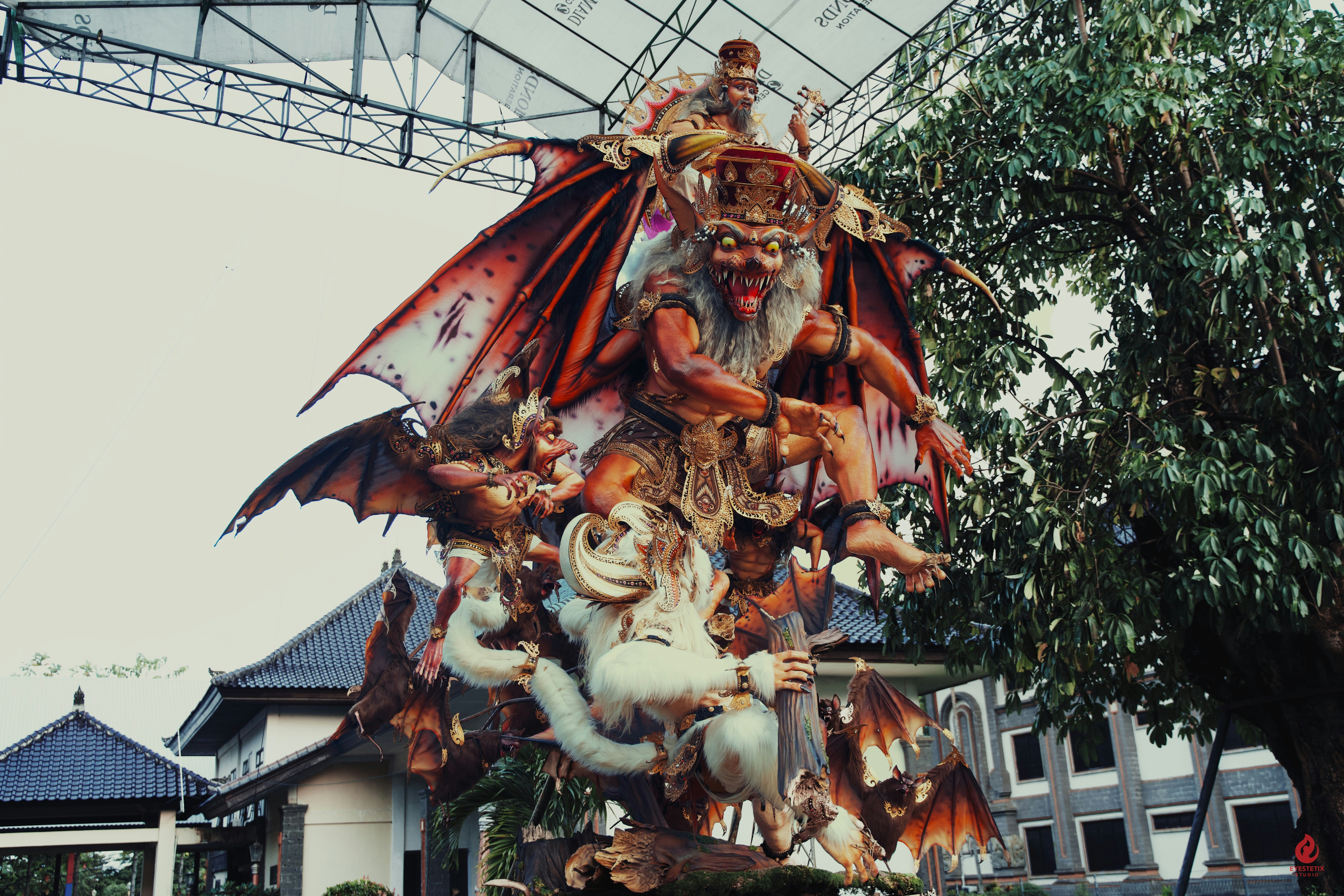 Intricate statue of mythical creatures with demonic figures.