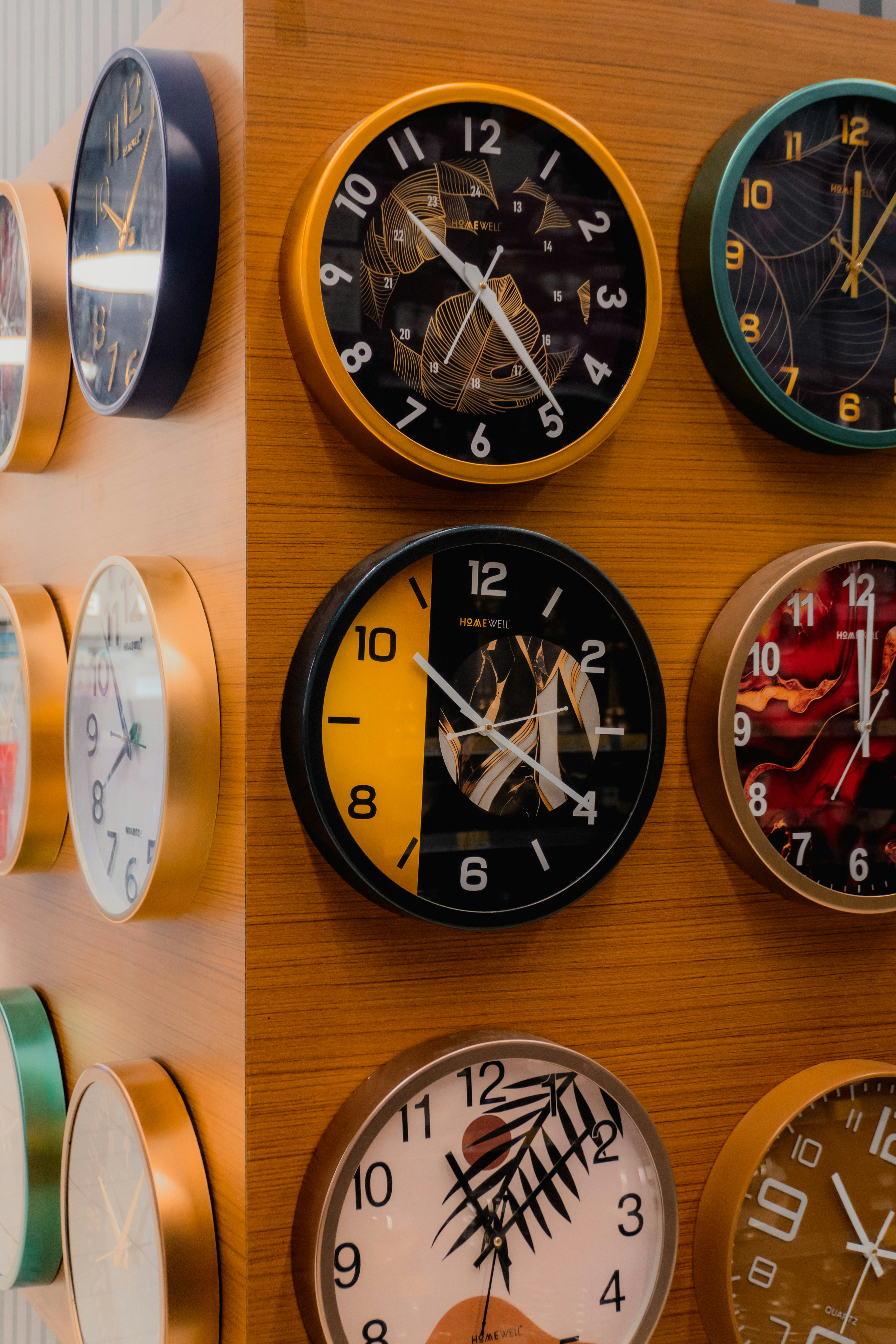 Several decorative clocks arranged on a wooden surface.