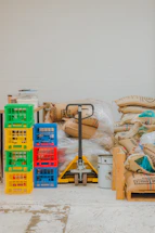Pallet jack with stacked crates and burlap sacks