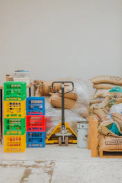 Pallet jack with stacked crates and burlap sacks
