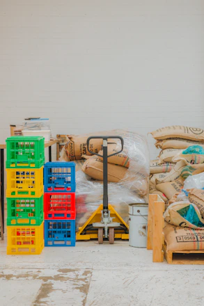 Pallet jack with stacked crates and burlap sacks