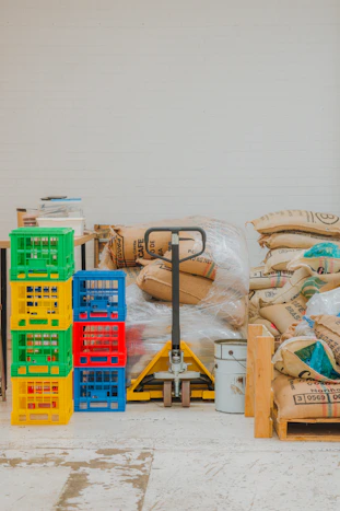 Pallet jack with stacked crates and burlap sacks