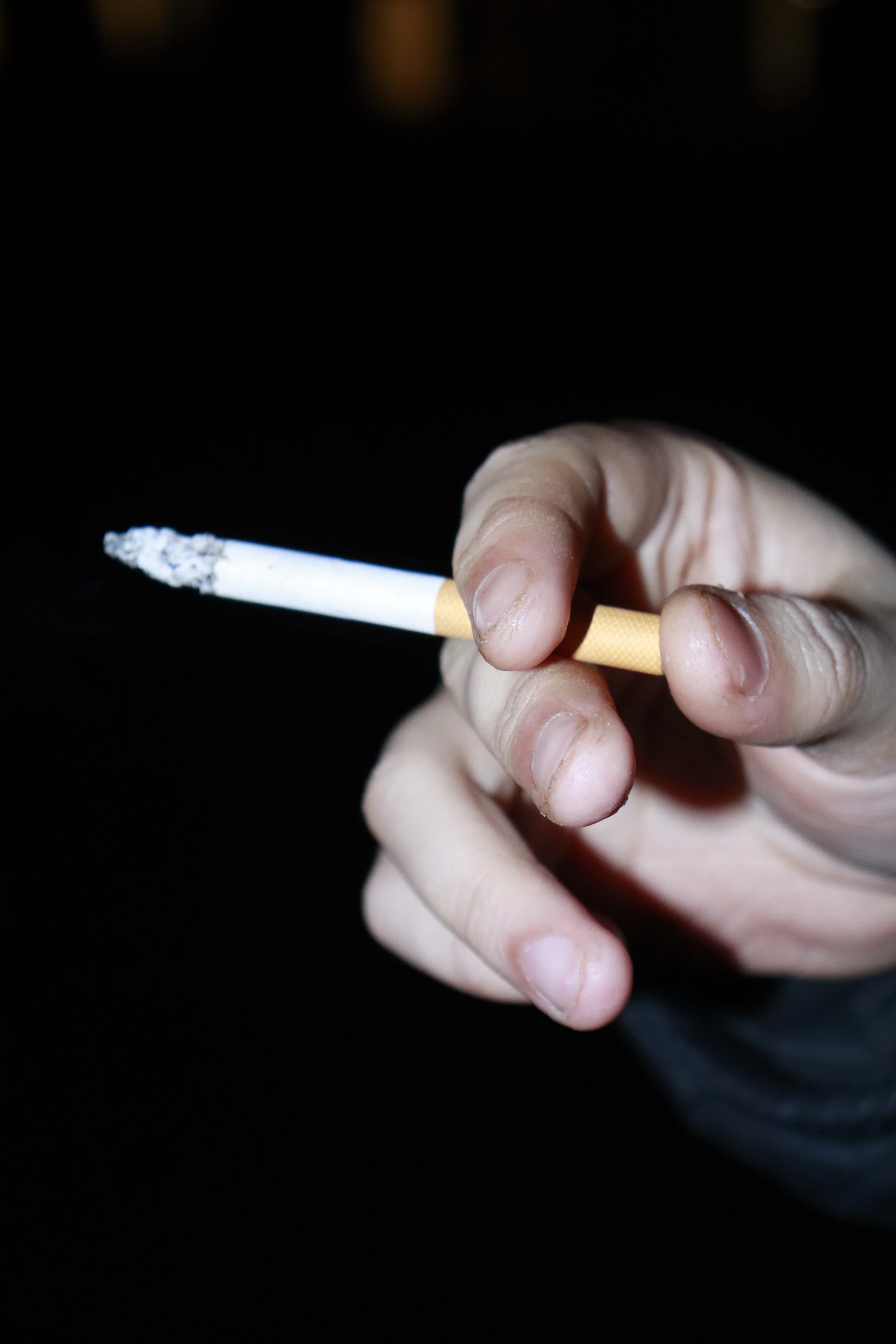 arms crossed holding a cigarette side pov Close-up Womans Manicured Arm Stock Photo 417498982 Hand holds two lit cigarettes
