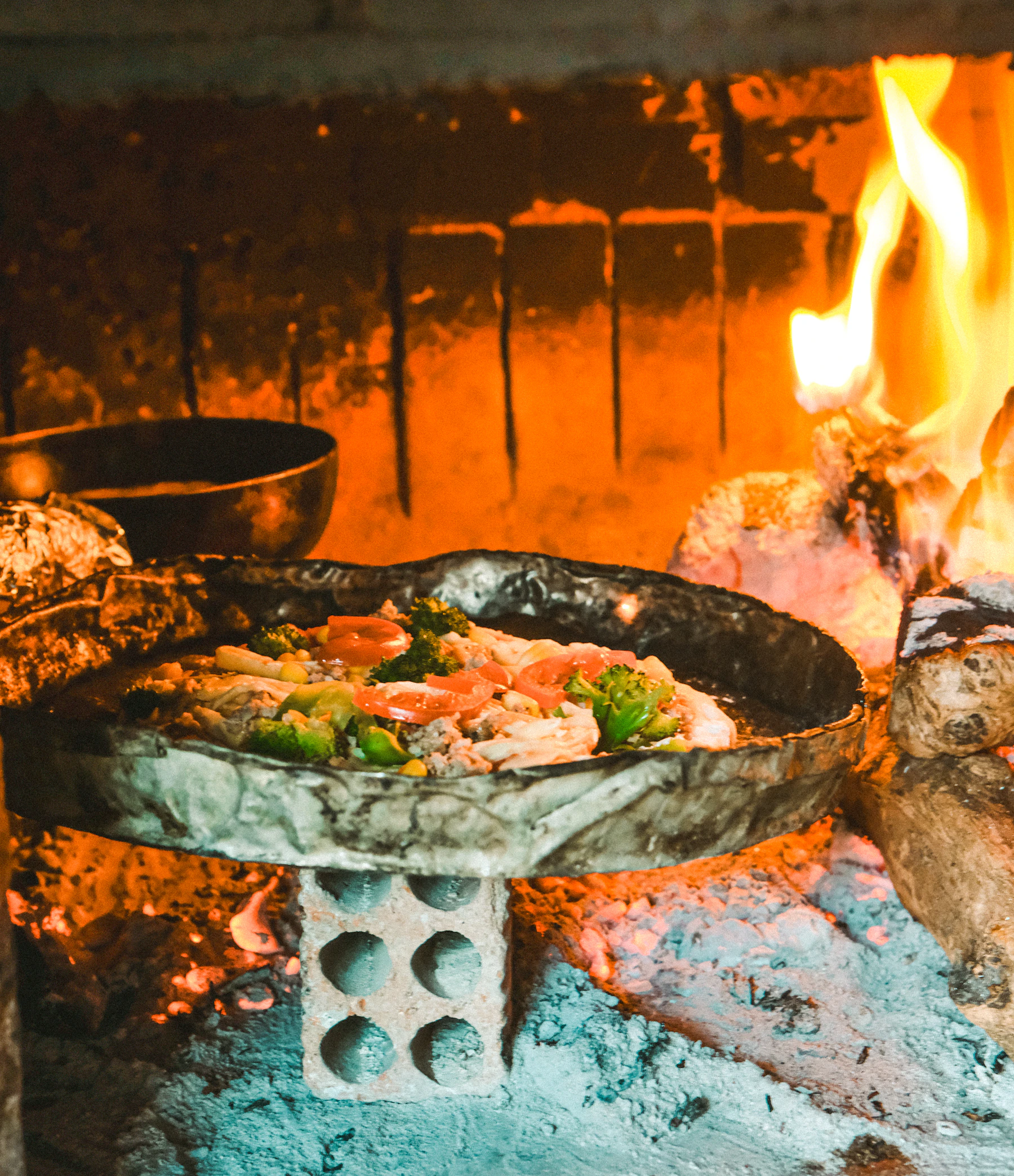 Pizza cooking in a wood-fired oven