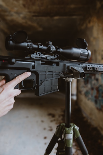 Hunter with trekking poles on steep mountain terrain