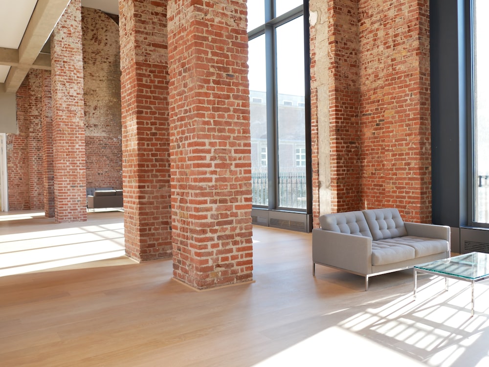 Open brick loft with tall windows, flexible floor space, and modern finishes