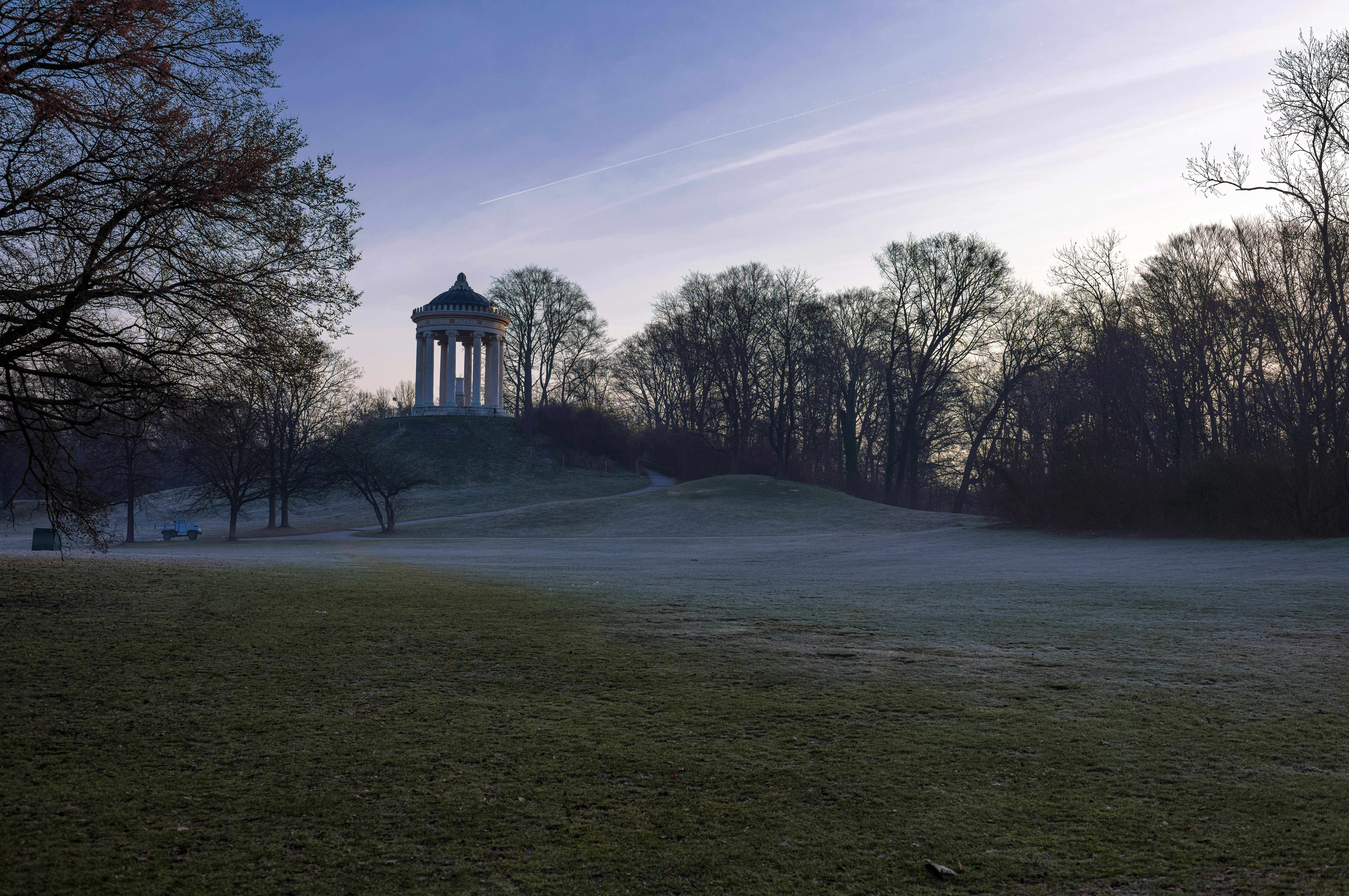 Temple on a hill surrounded by trees and mist