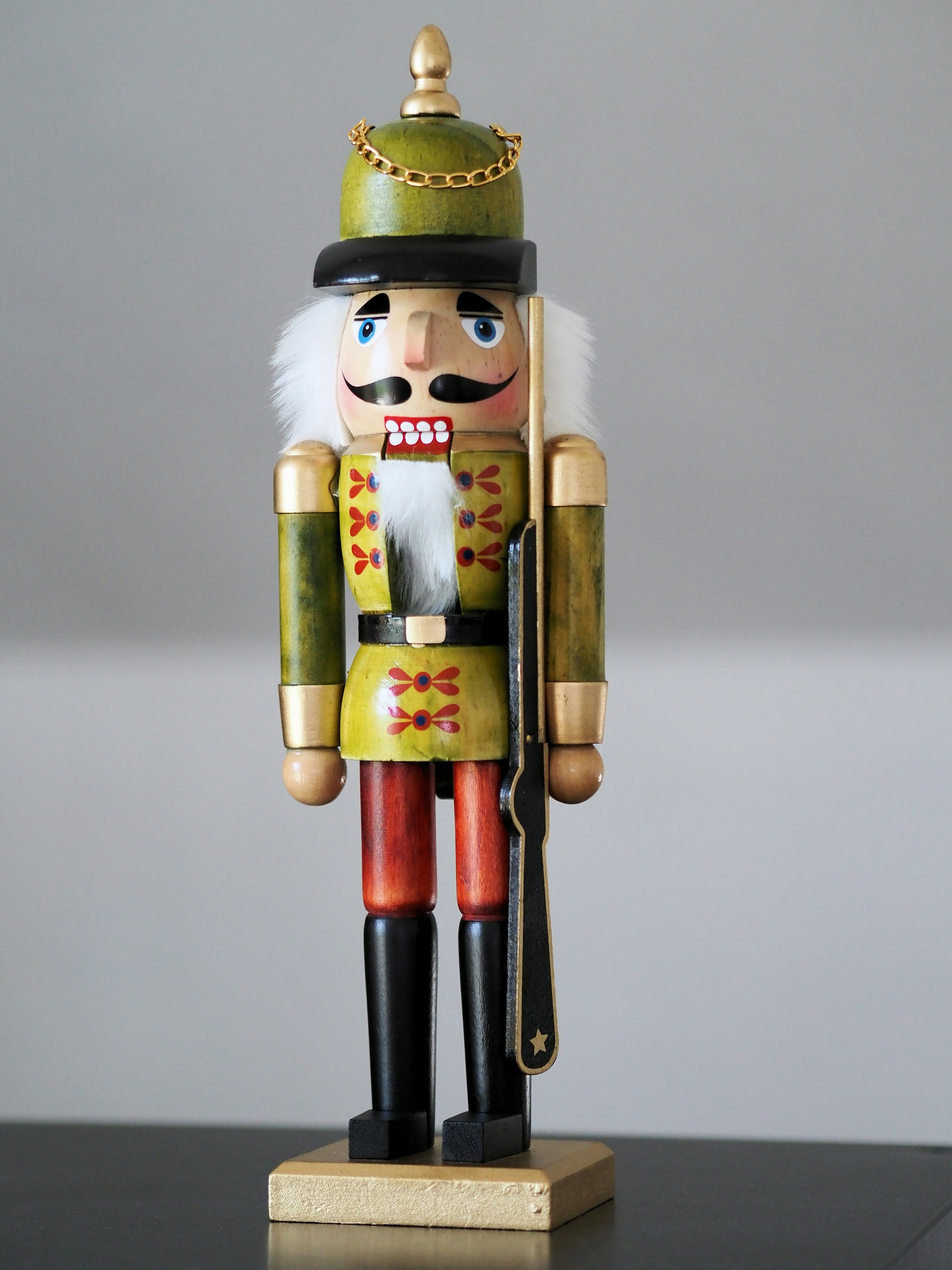 A decorative wooden nutcracker soldier with a rifle