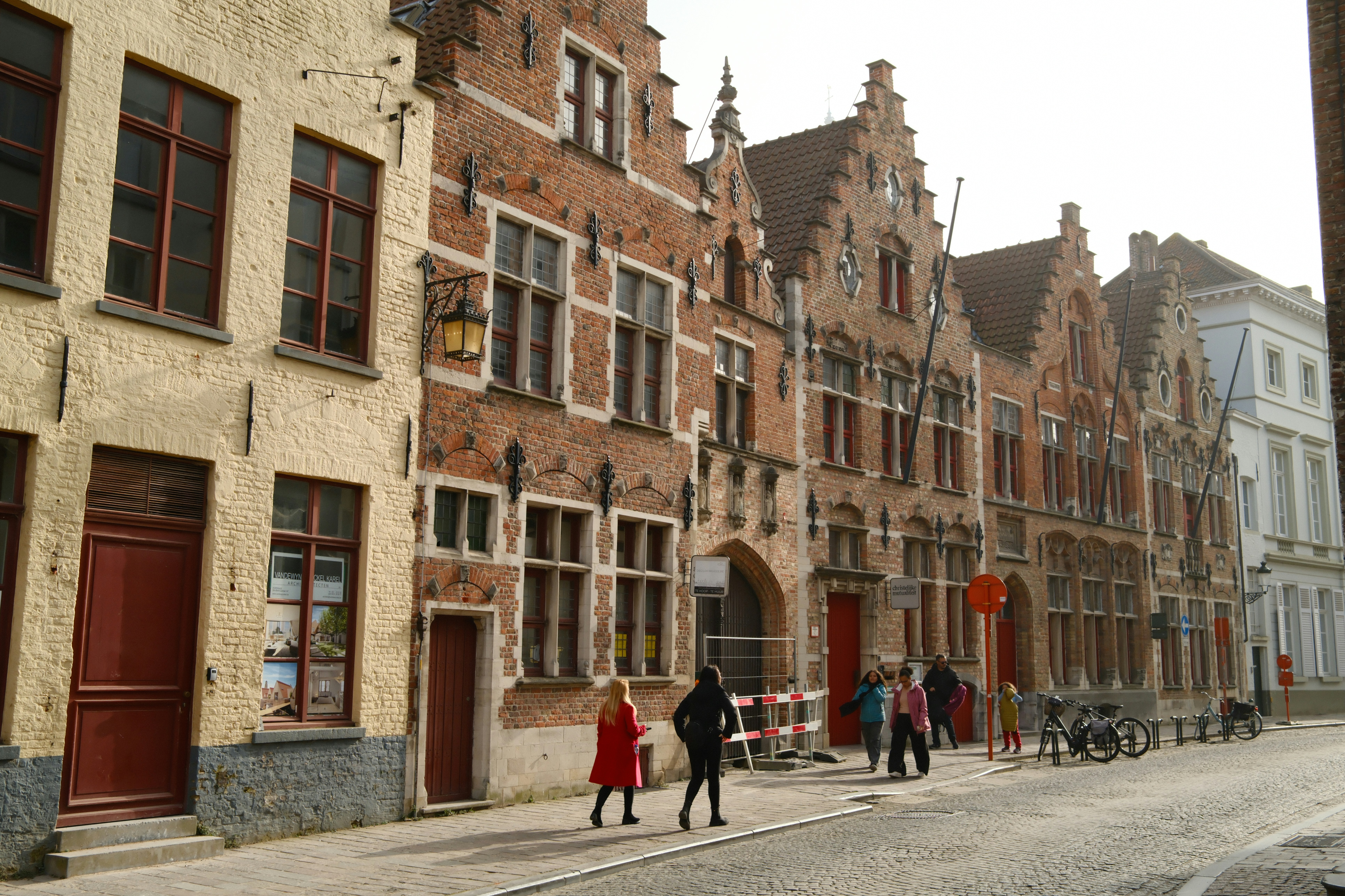 Row of historic brick buildings with stepped gables.