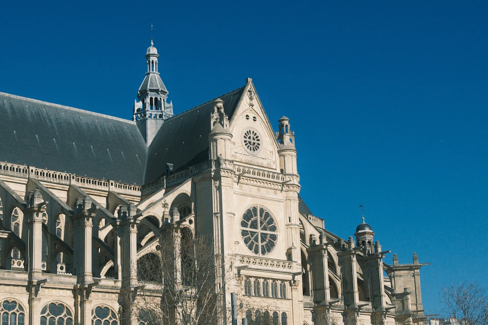 Large ornate white stone cathedral dominates the landscape with its tall clock tower